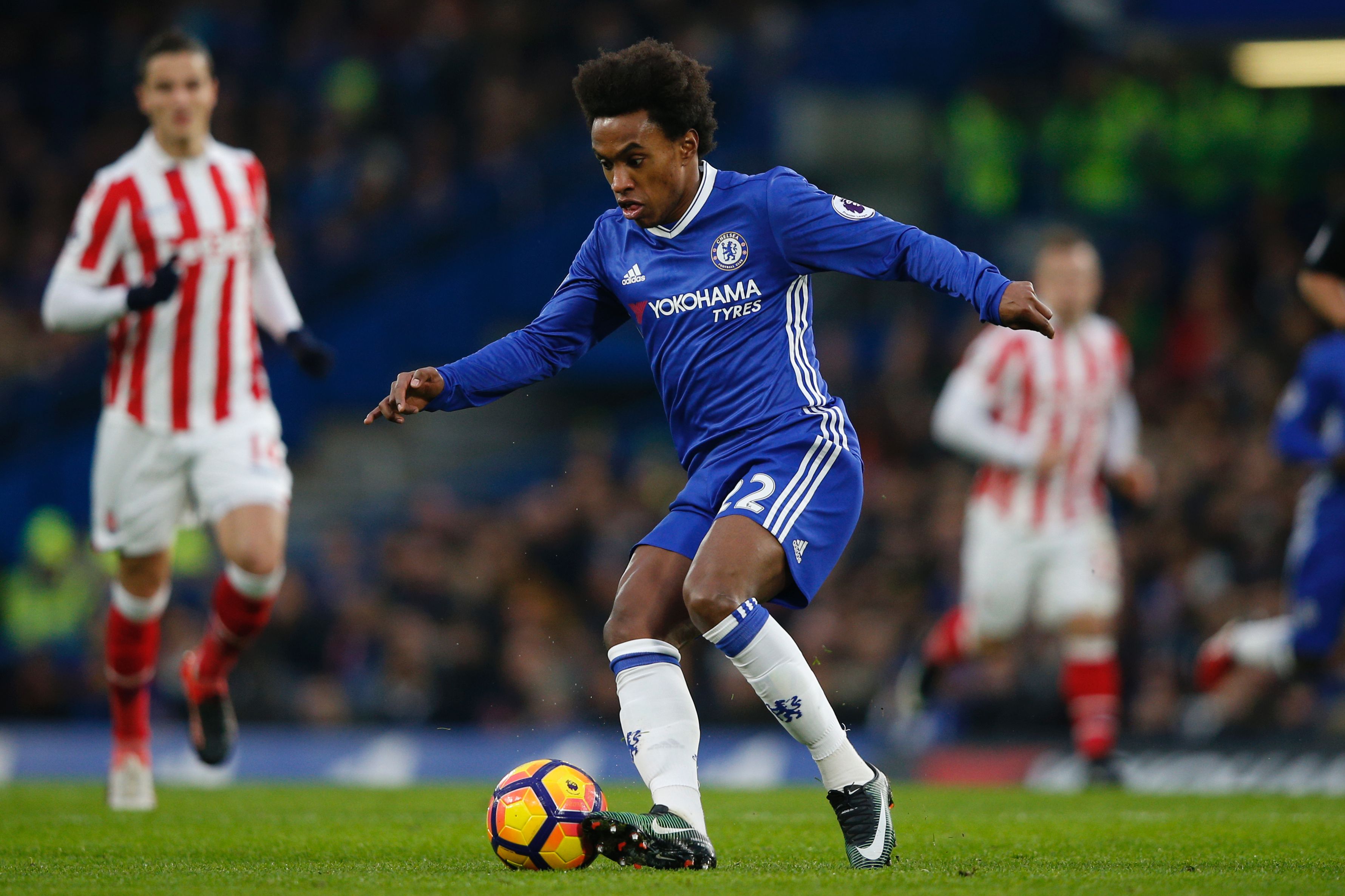 Chelsea's Brazilian midfielder Willian controls the ball during the English Premier League football match between Chelsea and Stoke City at Stamford Bridge in London on December 31, 2016. / AFP / Adrian DENNIS / RESTRICTED TO EDITORIAL USE. No use with unauthorized audio, video, data, fixture lists, club/league logos or 'live' services. Online in-match use limited to 75 images, no video emulation. No use in betting, games or single club/league/player publications. / (Photo credit should read ADRIAN DENNIS/AFP/Getty Images)