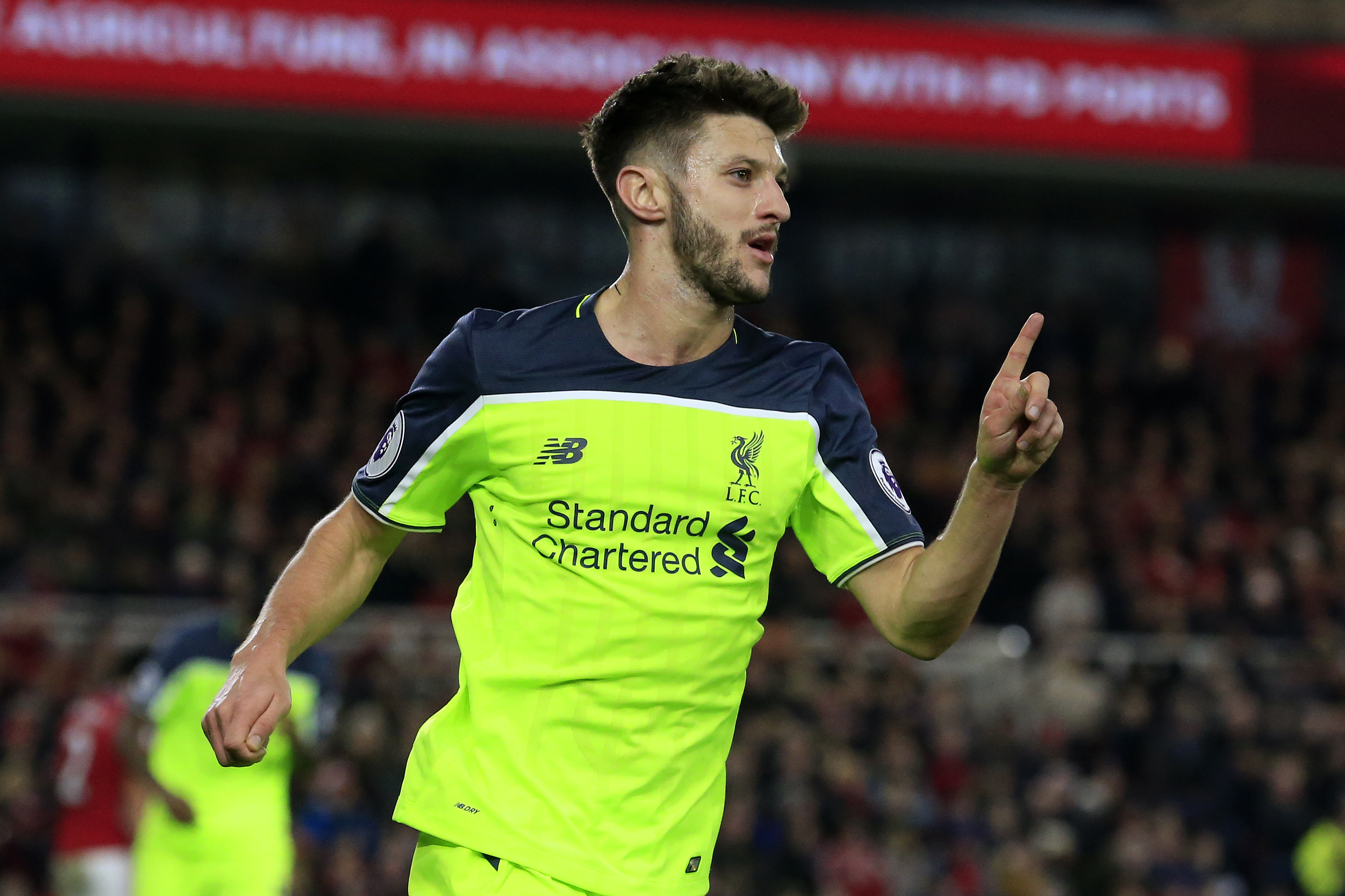 Liverpool's English midfielder Adam Lallana celebrates scoring his team's third goal during the English Premier League football match between Middlesbrough and Liverpool at Riverside Stadium in Middlesbrough, northeast England on December 14, 2016. / AFP / Lindsey PARNABY / RESTRICTED TO EDITORIAL USE. No use with unauthorized audio, video, data, fixture lists, club/league logos or 'live' services. Online in-match use limited to 75 images, no video emulation. No use in betting, games or single club/league/player publications. / (Photo credit should read LINDSEY PARNABY/AFP/Getty Images)