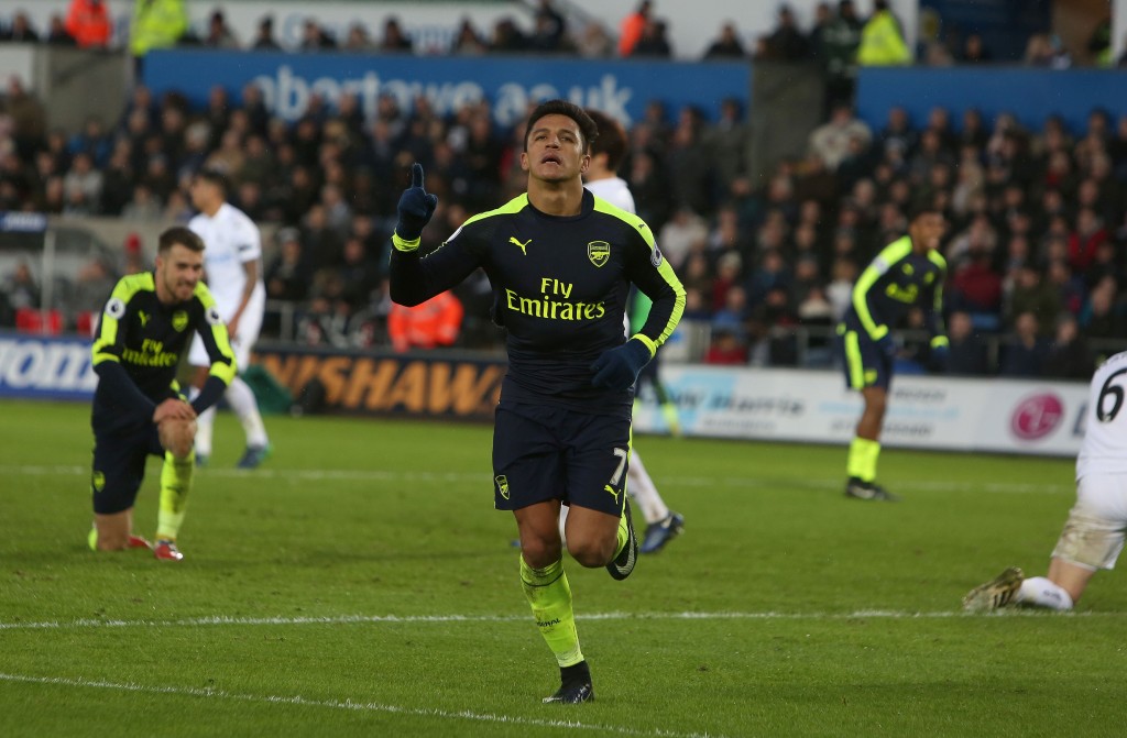 Arsenal's Chilean striker Alexis Sanchez celebrates scoring his team's fourth goal during the English Premier League football match between Swansea City and Arsenal at The Liberty Stadium in Swansea, south Wales on January 14, 2017. / AFP / Geoff CADDICK / RESTRICTED TO EDITORIAL USE. No use with unauthorized audio, video, data, fixture lists, club/league logos or 'live' services. Online in-match use limited to 75 images, no video emulation. No use in betting, games or single club/league/player publications. / (Photo credit should read GEOFF CADDICK/AFP/Getty Images)