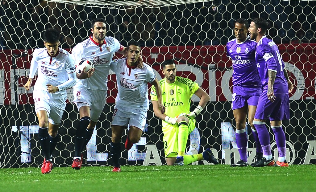 Sevilla's players (L) celebrate after Real Madrid's Brazilian defender Danilo (2ndR) scored an own goal during the Spanish Copa del Rey (King's Cup) round of 16 second leg football match Sevilla FC vs Real Madrid CF at the Ramon Sanchez Pizjuan stadium in Sevilla on January 12, 2017. / AFP / CRISTINA QUICLER (Photo credit should read CRISTINA QUICLER/AFP/Getty Images)