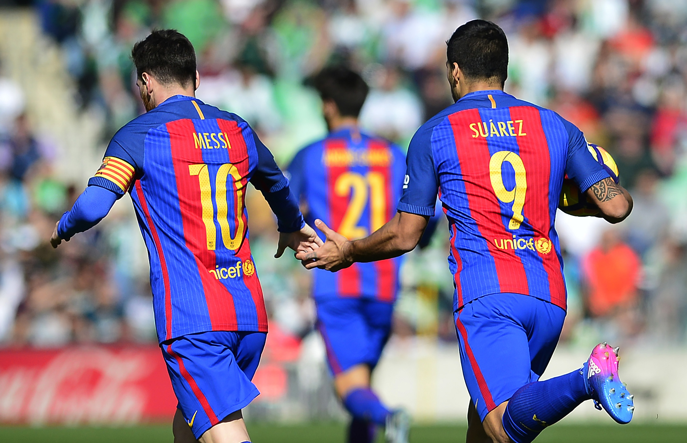 Barcelona's Uruguayan forward Luis Suarez (R) celebrates a goal with Barcelona's Argentinian forward Lionel Messi (L) during the Spanish league football match Real Betis vs FC Barcelona at the Benito Villamarin stadium in Sevilla on January 29, 2017. / AFP / CRISTINA QUICLER (Photo credit should read CRISTINA QUICLER/AFP/Getty Images)