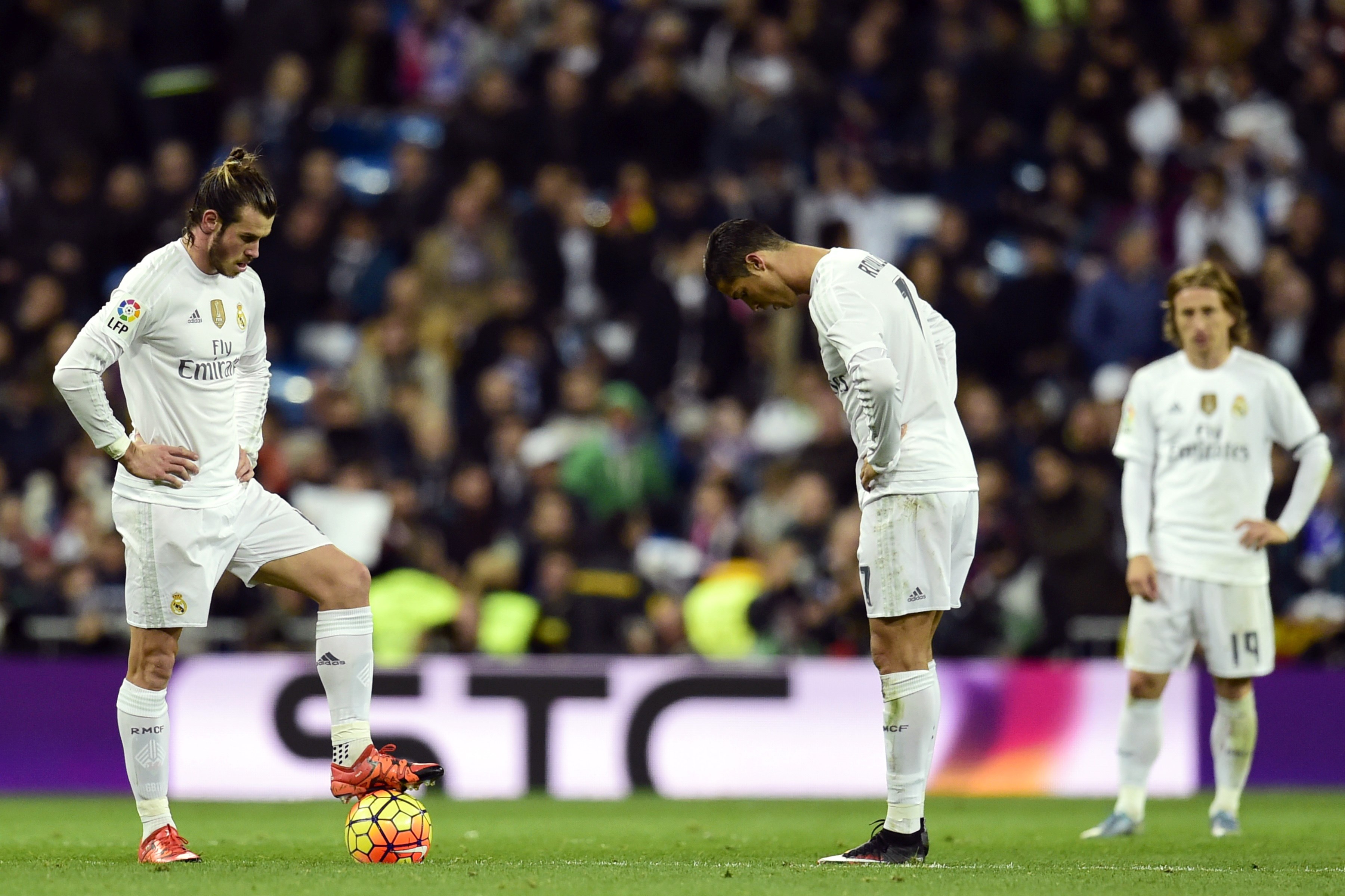 Real Madrid's Welsh forward Gareth Bale, Real Madrid's Portuguese forward Cristiano Ronaldo and Real Madrid's Croatian midfielder Luka Modric stand during the Spanish league "Clasico" football match Real Madrid CF vs FC Barcelona at the Santiago Bernabeu stadium in Madrid on November 21, 2015. AFP PHOTO/ JAVIER SORIANO (Photo credit should read JAVIER SORIANO/AFP/Getty Images)