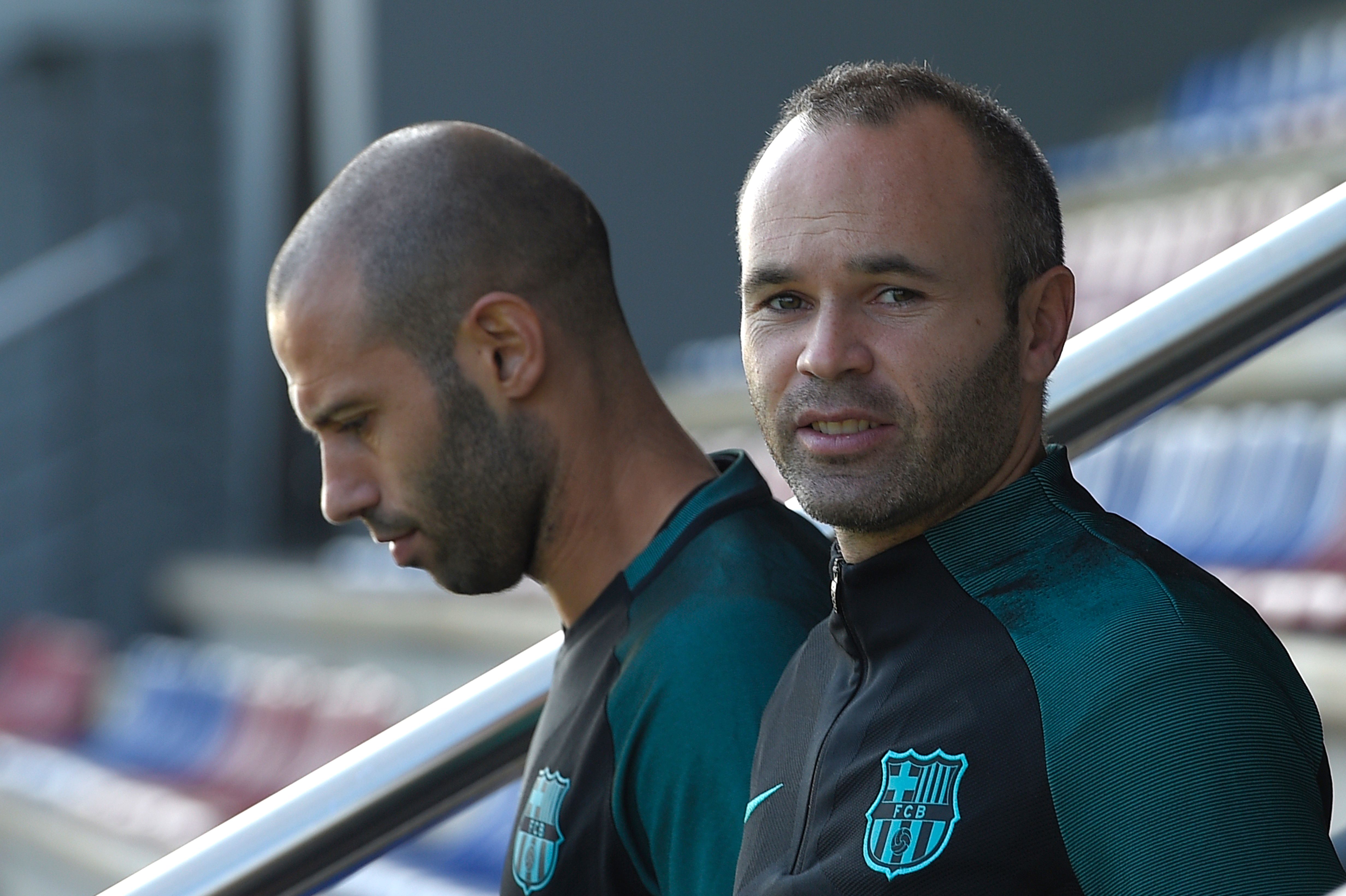 Barcelona's midfielder Andres Iniesta (R) and Barcelona's Argentinian defender Javier Mascherano arrive for a training session at the Sports Center FC Barcelona Joan Gamper in Sant Joan Despi, near Barcelona on October 18, 2016, on the eve of the UEFA Champions League football match FC Barcelona vs Manchester City. / AFP / LLUIS GENE (Photo credit should read LLUIS GENE/AFP/Getty Images)