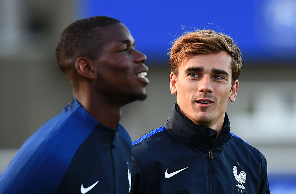 France's forward Antoine Griezmann (R) speaks to France's midfielder Paul Pogba during a training session in Clairefontaine-en-Yvelines near Paris on October 4, 2016 ahead of the 2018 FIFA World Cup football matches against Bulgaria on October 7 and the Netherlands on October 10. (Photo by Franck Fife/AFP/Getty Images)