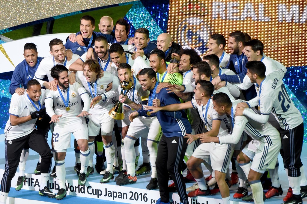 Real Madrid players and staff celebrate with their trophy after winning the Club World Cup football final match between Kashima Antlers of Japan and Real Madrid of Spain at Yokohama International stadium in Yokohama on December 18, 2016. / AFP / TORU YAMANAKA (Photo credit should read TORU YAMANAKA/AFP/Getty Images)