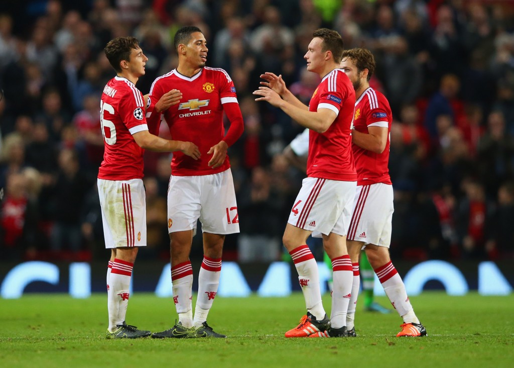 MANCHESTER, ENGLAND - SEPTEMBER 30: (L-R) Matteo Darmian, Chris Smalling, Phil Jones and Daley Blind of Manchester United celebrate victory after the UEFA Champions League Group B match between Manchester United FC and VfL Wolfsburg at Old Trafford on September 30, 2015 in Manchester, United Kingdom. (Photo by Alex Livesey/Bongarts/Getty Images)