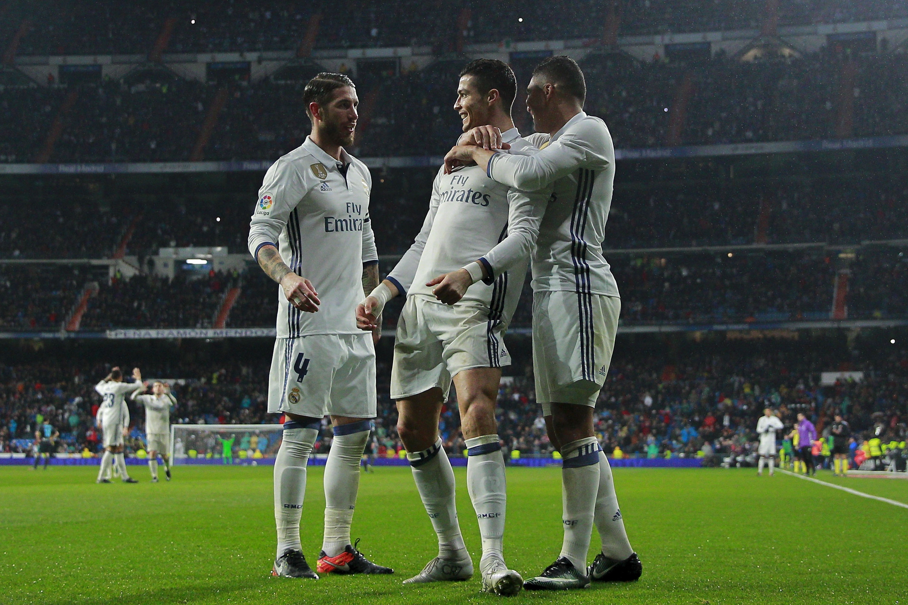 MADRID, SPAIN - JANUARY 29: Cristiano Ronaldo (2ndR) celebrates scoring their second goal with teammate Carlos Casemiro (R) and Sergio Ramos (L) during the La Liga match between Real Madrid CF and Real Sociedad de Futbol at Estadio Santiago Bernabeu on January 29, 2017 in Madrid, Spain. (Photo by Gonzalo Arroyo Moreno/Getty Images)