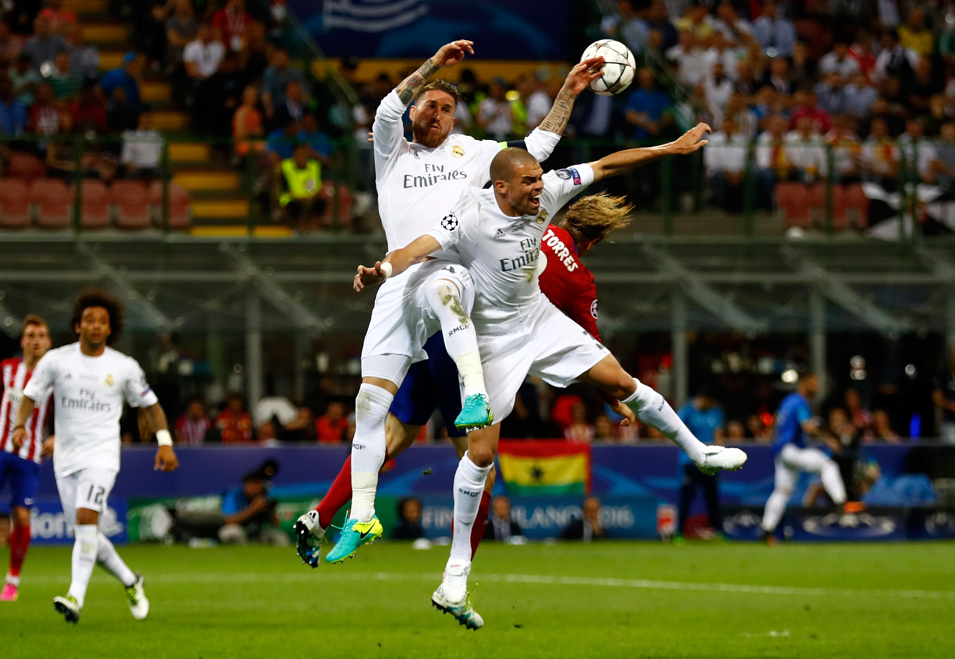 MILAN, ITALY - MAY 28: Fernando Torres of Atletico Madrid is challemged by Sergio Ramos of Real Madrid and Pepe of Real Madrid during the UEFA Champions League Final match between Real Madrid and Club Atletico de Madrid at Stadio Giuseppe Meazza on May 28, 2016 in Milan, Italy. (Photo by Clive Rose/Getty Images)