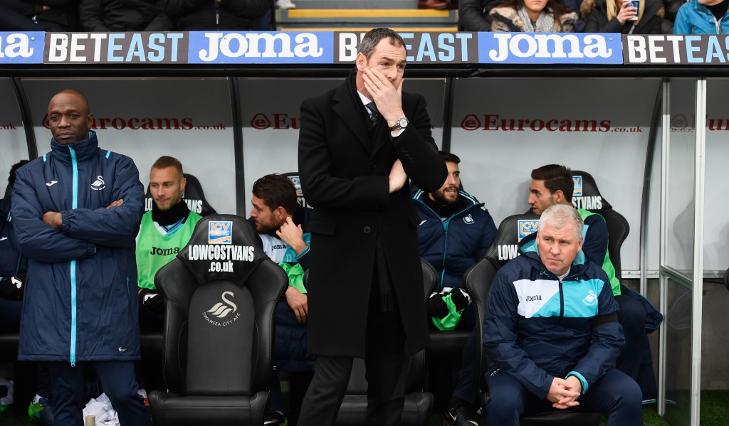 SWANSEA, WALES - JANUARY 14: Paul Clement manager of Swansea City looks on from the bench alongside new assistant Claude Makelele (L) prior to the Premier League match between Swansea City and Arsenal at Liberty Stadium on January 14, 2017 in Swansea, Wales. (Photo by Stu Forster/Getty Images)