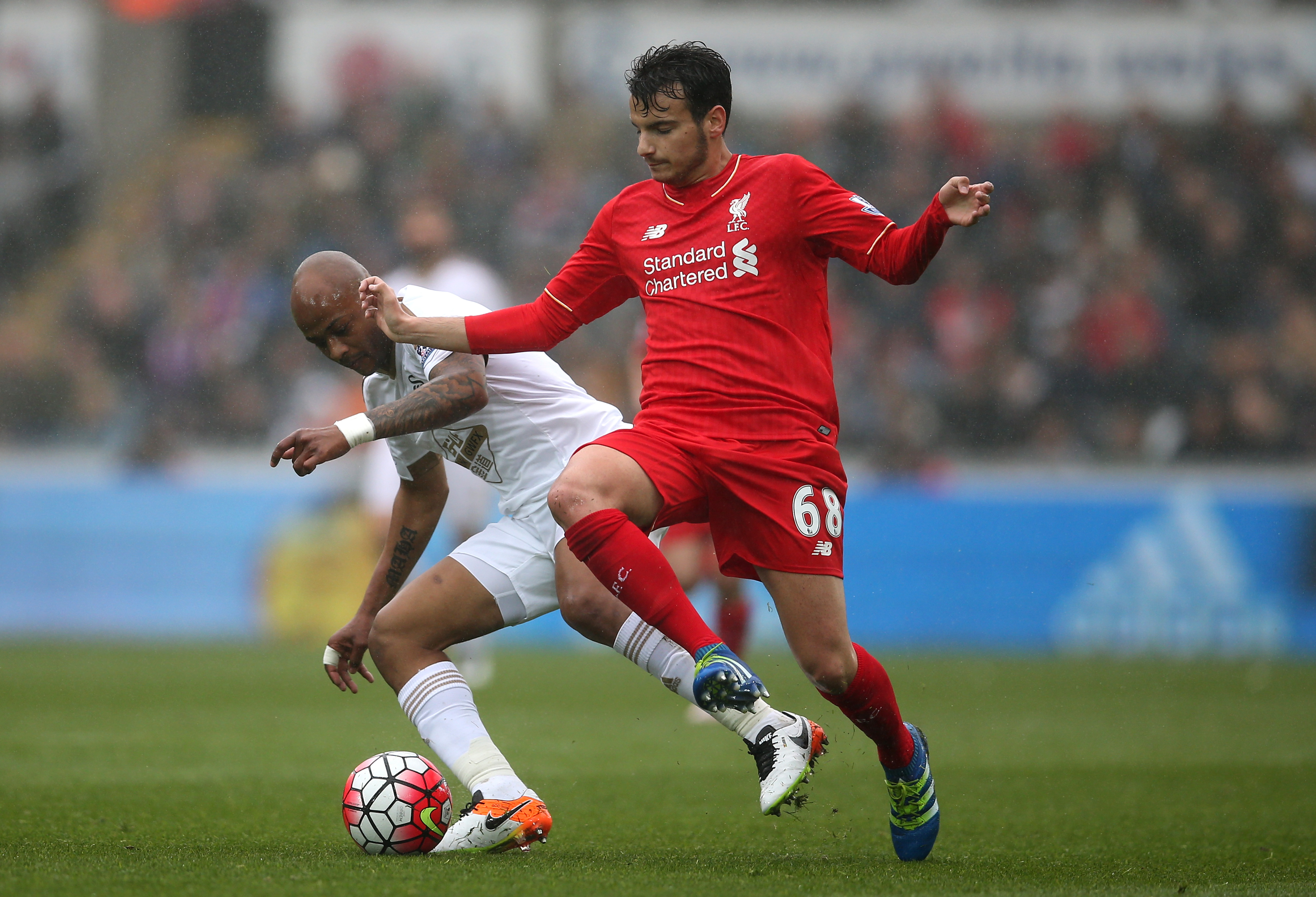 SWANSEA, WALES - MAY 01: Pedro Chirivella of Liverpool is closed down by Andre Ayew of Swansea City during the Barclays Premier League match between Swansea City and Liverpool at The Liberty Stadium on May 1, 2016 in Swansea, Wales. (Photo by Steve Bardens/Getty Images)