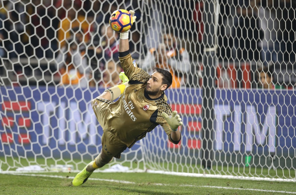 DOHA, QATAR - DECEMBER 23: Gianluigi Donnarumma ,Goalkeeper of AC Milan saving the ball from Juventus FC's Penalty during the Supercoppa TIM Doha 2016 match between Juventus FC and AC Milan at the Jassim Bin Hamad Stadium on December 23, 2016 in Doha, Qatar. (Photo by AK BijuRaj/Getty Images)