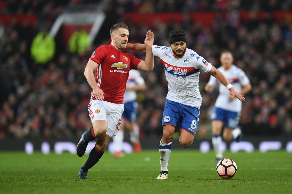 Manchester United's English defender Luke Shaw (R) vies with Wigan Athletic's English midfielder Sam Morsy (R) during the English FA Cup fourth round football match between Manchester United and Wigan Athletic at Old Trafford in Manchester, north west England, on January 29, 2017. / AFP / Paul ELLIS / RESTRICTED TO EDITORIAL USE. No use with unauthorized audio, video, data, fixture lists, club/league logos or 'live' services. Online in-match use limited to 75 images, no video emulation. No use in betting, games or single club/league/player publications. / (Photo credit should read PAUL ELLIS/AFP/Getty Images)