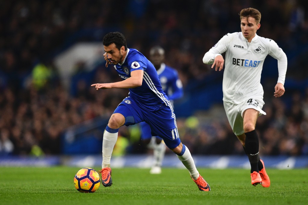 Chelsea's Spanish midfielder Pedro (L) runs with the ball pursued by Swansea City's English midfielder Tom Carroll (R) during the English Premier League football match between Chelsea and Swansea at Stamford Bridge in London on February 25, 2017. / AFP / Glyn KIRK / RESTRICTED TO EDITORIAL USE. No use with unauthorized audio, video, data, fixture lists, club/league logos or 'live' services. Online in-match use limited to 75 images, no video emulation. No use in betting, games or single club/league/player publications. / (Photo credit should read GLYN KIRK/AFP/Getty Images)