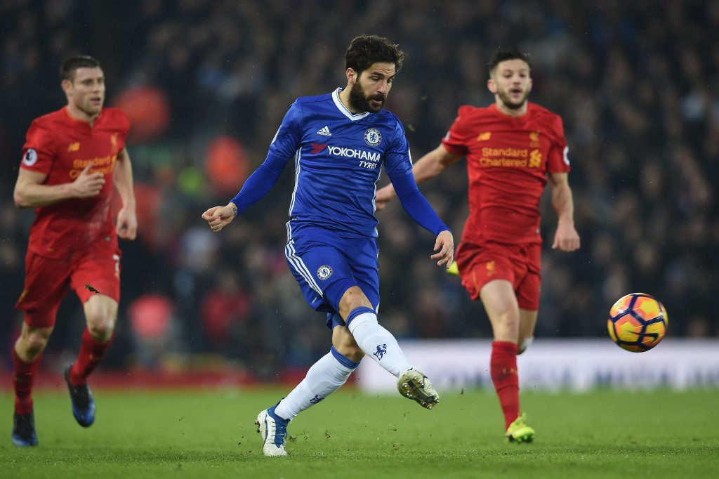 Chelsea's Spanish midfielder Cesc Fabregas (C) crosses the ball during the English Premier League football match between Liverpool and Chelsea at Anfield in Liverpool, north west England on January 31, 2017. The match ended in a draw at 1-1. / AFP / PAUL ELLIS / RESTRICTED TO EDITORIAL USE. No use with unauthorized audio, video, data, fixture lists, club/league logos or 'live' services. Online in-match use limited to 75 images, no video emulation. No use in betting, games or single club/league/player publications. / (Photo credit should read PAUL ELLIS/AFP/Getty Images)