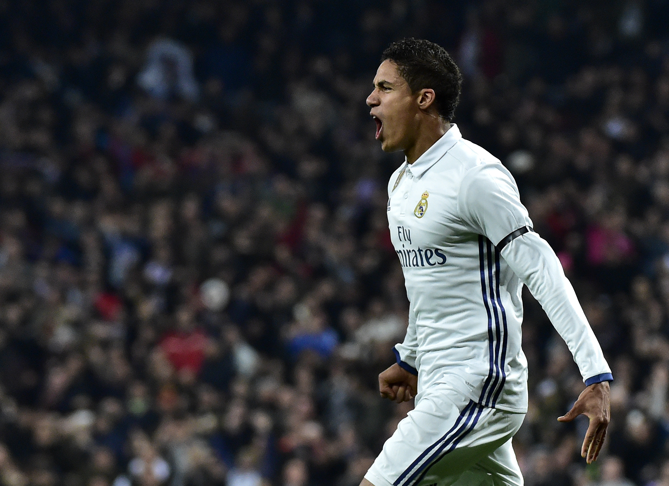 Real Madrid's French defender Raphael Varane celebrates after scoring during the Spanish Copa del Rey (King's Cup) round of 16 first leg football match Real Madrid CF vs Sevilla FC at the Santiago Bernabeu stadium in Madrid on January 4, 2017. / AFP / GERARD JULIEN (Photo credit should read GERARD JULIEN/AFP/Getty Images)