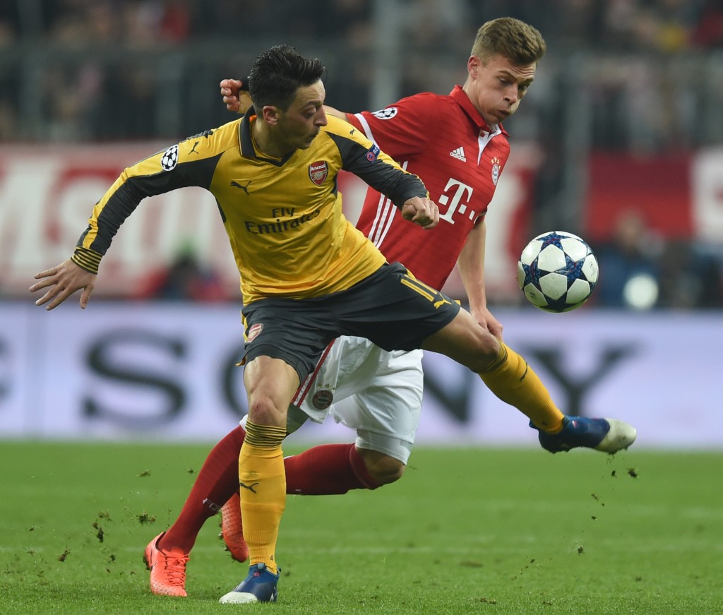 Arsenal's German midfielder Mesut Ozil (L) and Bayern Munich's midfielder Joshua Kimmich (R) vie for the ball during the UEFA Champions League round of sixteen football match between FC Bayern Munich and Arsenal in Munich, southern Germany, on February 15, 2017. / AFP / Christof STACHE (Photo credit should read CHRISTOF STACHE/AFP/Getty Images)