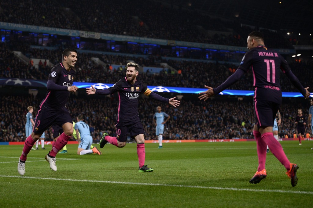 Barcelona's Argentinian striker Lionel Messi (C) celebrates scoring his team's first goal with Barcelona's Uruguayan striker Luis Suarez (L) and Barcelona's Brazilian striker Neymar during the UEFA Champions League group C football match between Manchester City and Barcelona at the Etihad Stadium in Manchester, north west England on November 1, 2016. / AFP / OLI SCARFF (Photo credit should read OLI SCARFF/AFP/Getty Images)