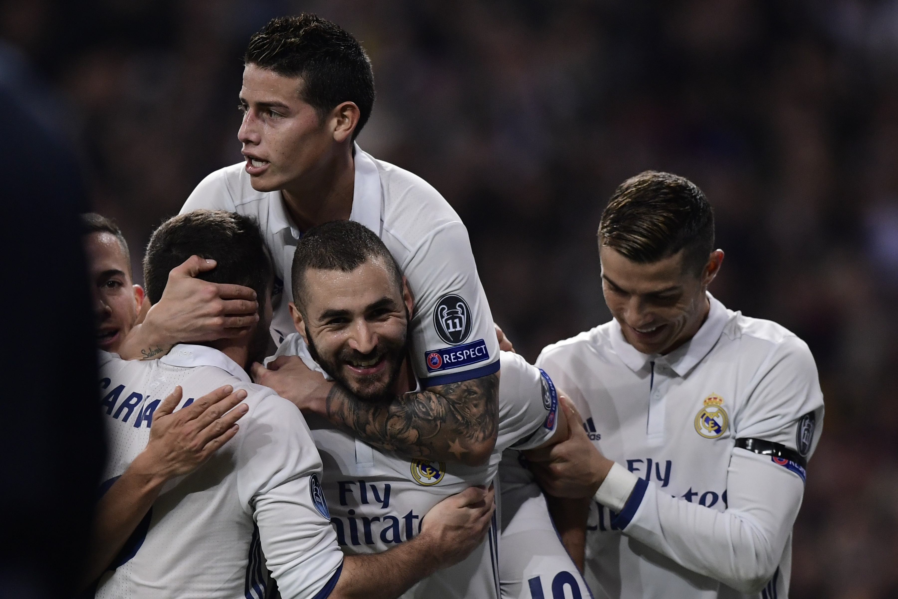Real Madrid's French forward Karim Benzema (C) celebrates a goal with teammates Real Madrid's Colombian midfielder James Rodriguez (top) and Real Madrid's Portuguese forward Cristiano Ronaldo (R) during the UEFA Champions League football match Real Madrid CF vs Borussia Dortmund at the Santiago Bernabeu stadium in Madrid on December 7, 2016. / AFP / JAVIER SORIANO (Photo credit should read JAVIER SORIANO/AFP/Getty Images)
