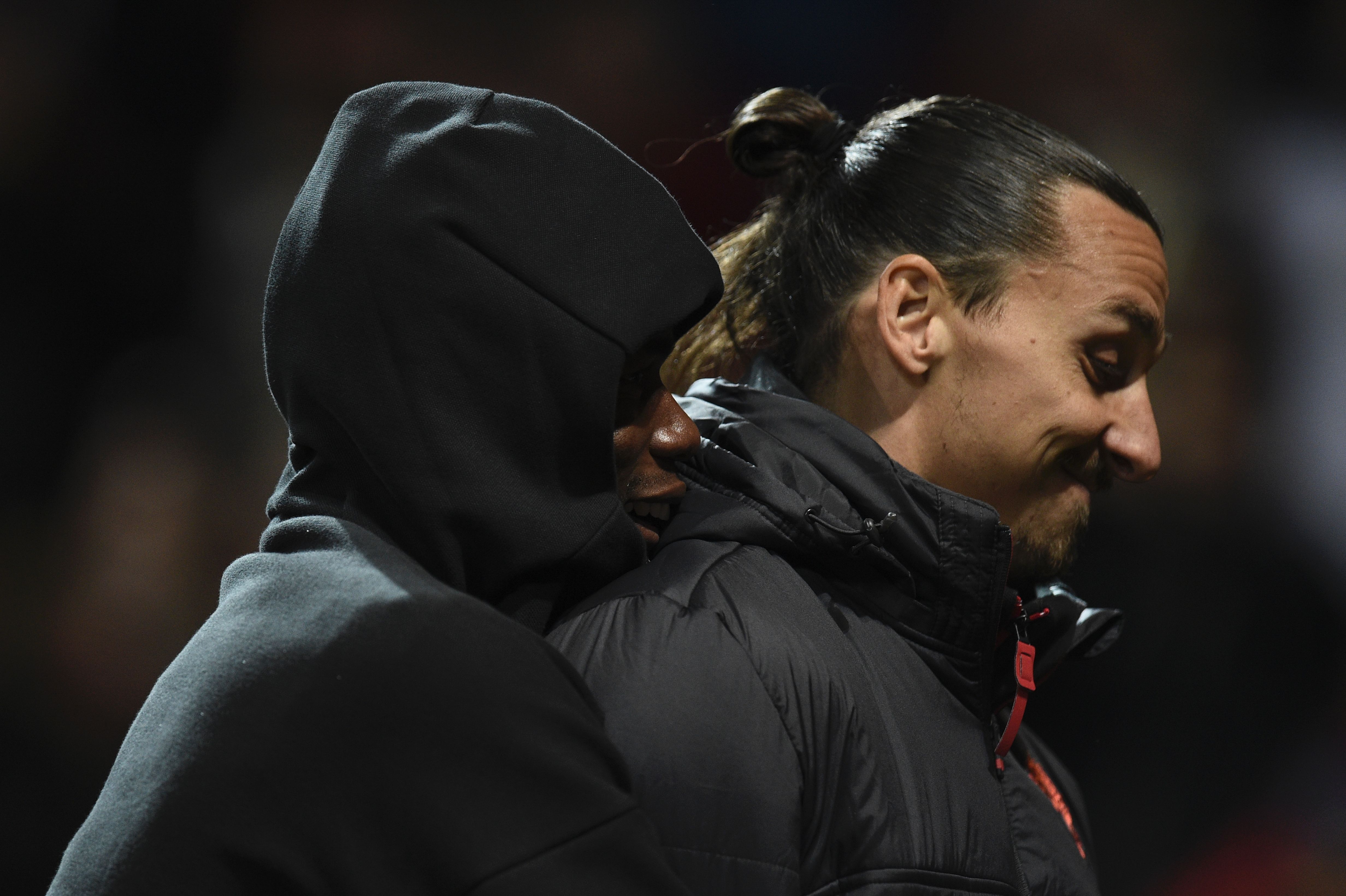 Manchester United's French midfielder Paul Pogba (L) hugs Manchester United's Swedish striker Zlatan Ibrahimovic (R) after the final whistle in the UEFA Europa League group A football match between Manchester United and Fenerbahce at Old Trafford in Manchester, north west England, on October 20, 2016. / AFP / OLI SCARFF (Photo credit should read OLI SCARFF/AFP/Getty Images)