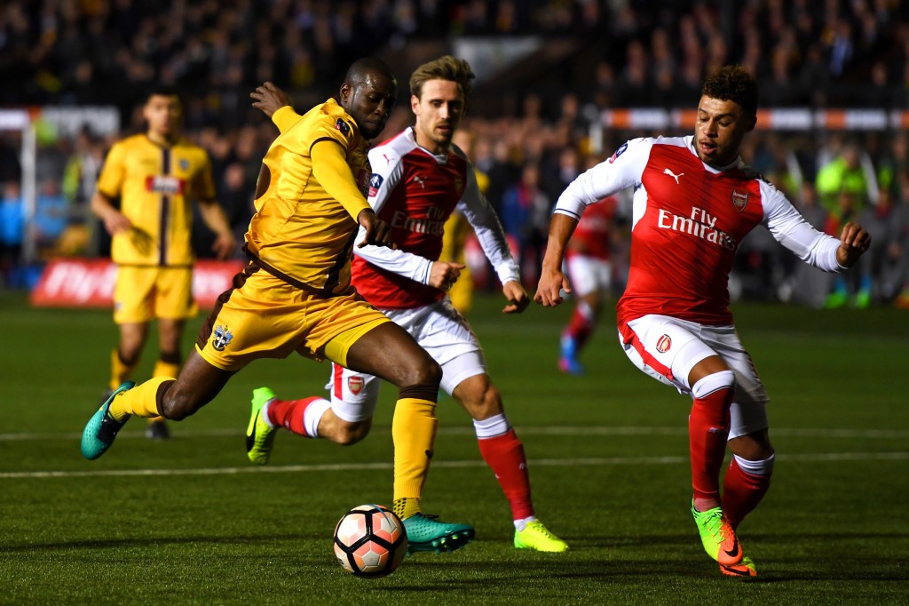 SUTTON, GREATER LONDON - FEBRUARY 20: Alex Oxlade-Chamberlain of Arsenal blocks at shot on goal from Bedsente Gomis of Sutton United during the Emirates FA Cup fifth round match between Sutton United and Arsenal on February 20, 2017 in Sutton, Greater London. (Photo by Mike Hewitt/Getty Images)