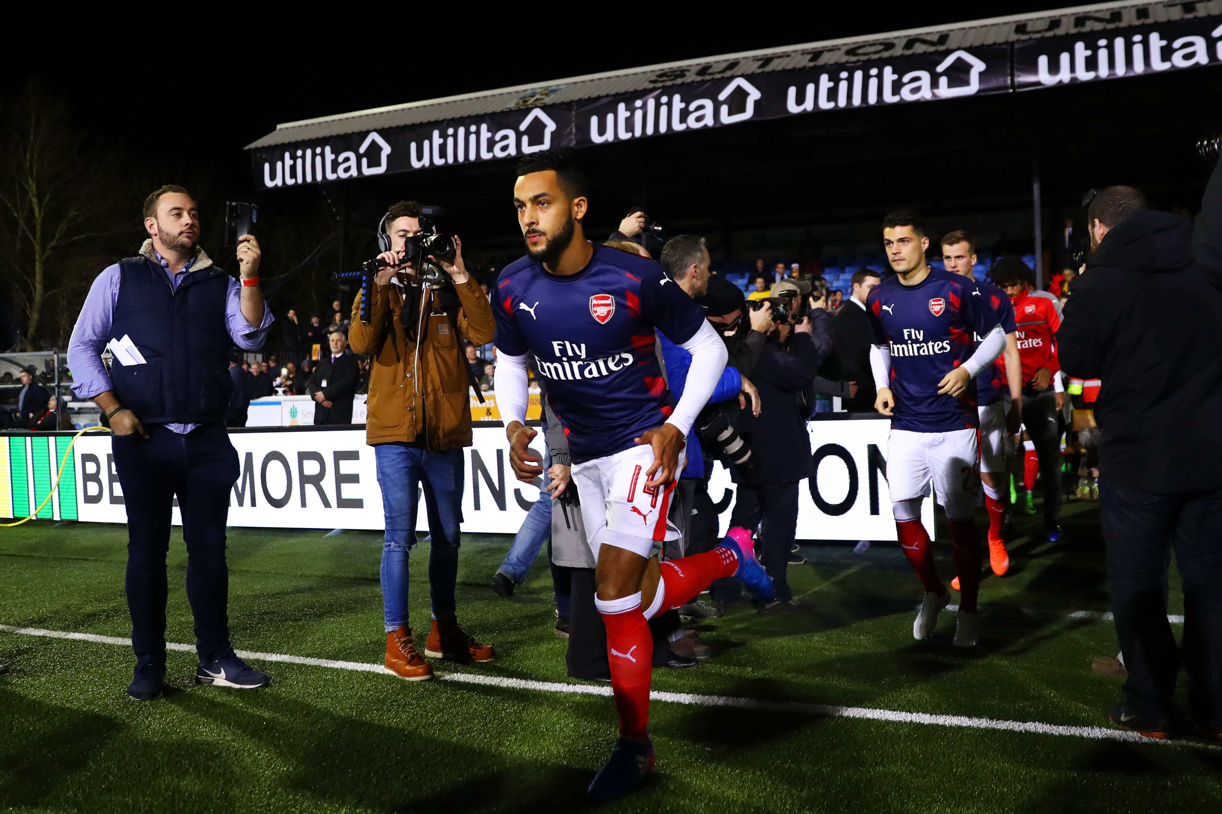 SUTTON, GREATER LONDON - FEBRUARY 20: Theo Walcott, Granit Xhaka and Rob Holding of Arsenal run out for the warm-up before the Emirates FA Cup fifth round match between Sutton United and Arsenal on February 20, 2017 in Sutton, Greater London. (Photo by Clive Rose/Getty Images)