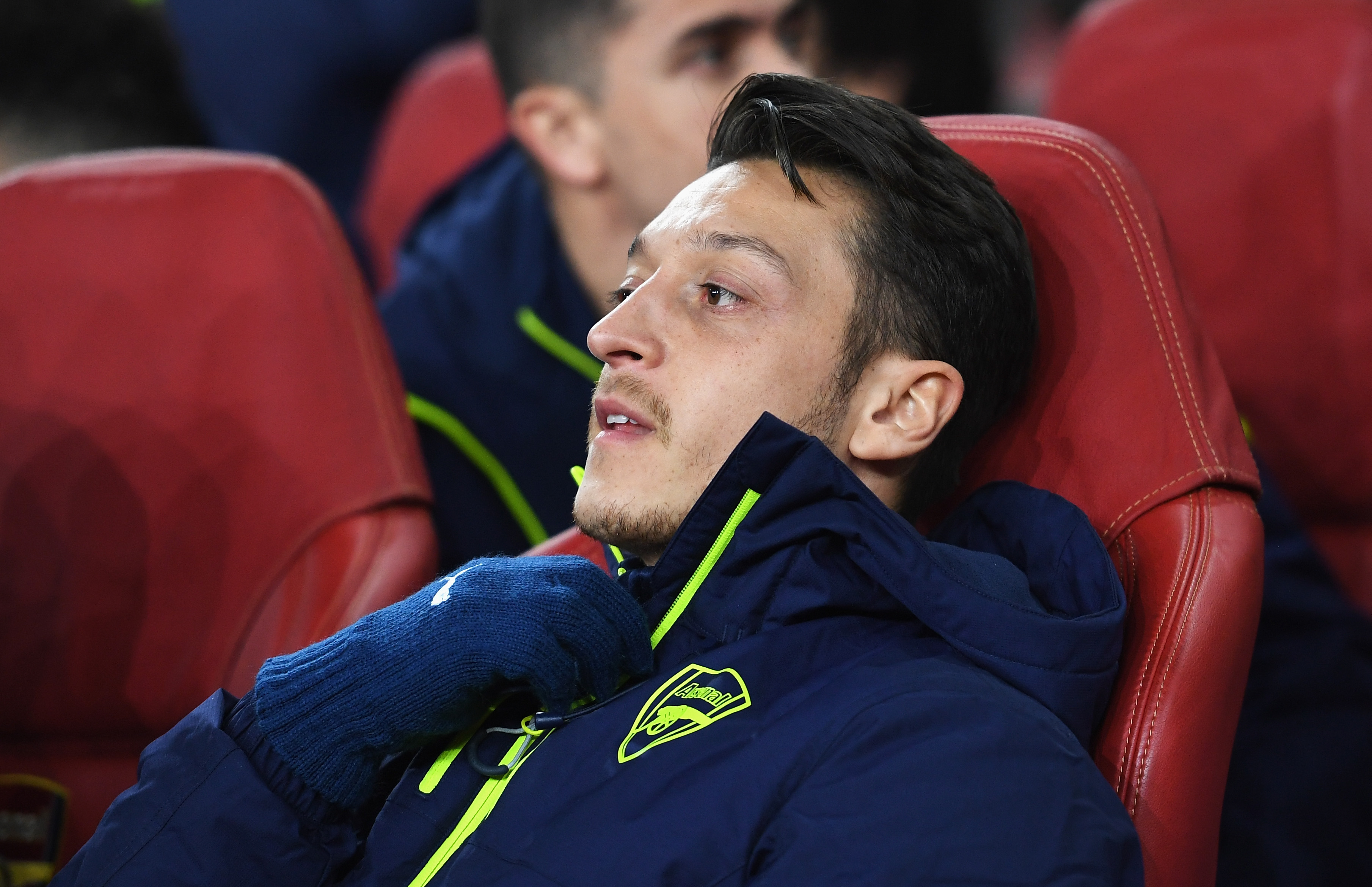 LONDON, ENGLAND - MARCH 07: Mesut Oezil of Arsenal looks on from the bench prior to the UEFA Champions League Round of 16 second leg match between Arsenal FC and FC Bayern Muenchen at Emirates Stadium on March 7, 2017 in London, United Kingdom. (Photo by Shaun Botterill/Getty Images)