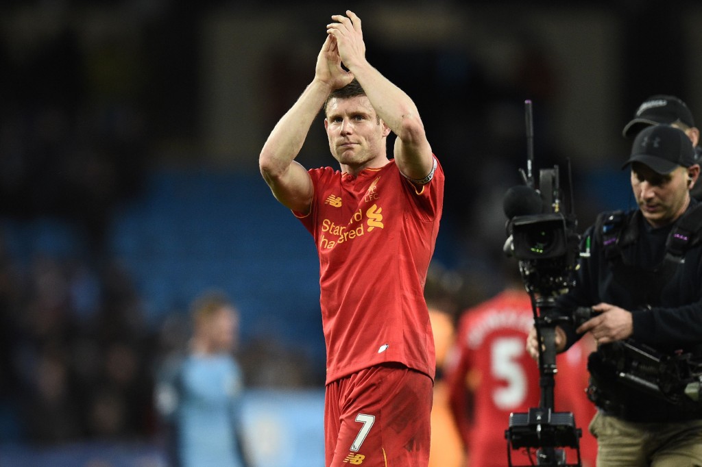 Liverpool's English midfielder James Milner applauds supporters on the pitch after the English Premier League football match between Manchester City and Liverpool at the Etihad Stadium in Manchester, north west England, on March 19, 2017. The game finished 1-1. / AFP PHOTO / Oli SCARFF / RESTRICTED TO EDITORIAL USE. No use with unauthorized audio, video, data, fixture lists, club/league logos or 'live' services. Online in-match use limited to 75 images, no video emulation. No use in betting, games or single club/league/player publications. / (Photo credit should read OLI SCARFF/AFP/Getty Images)