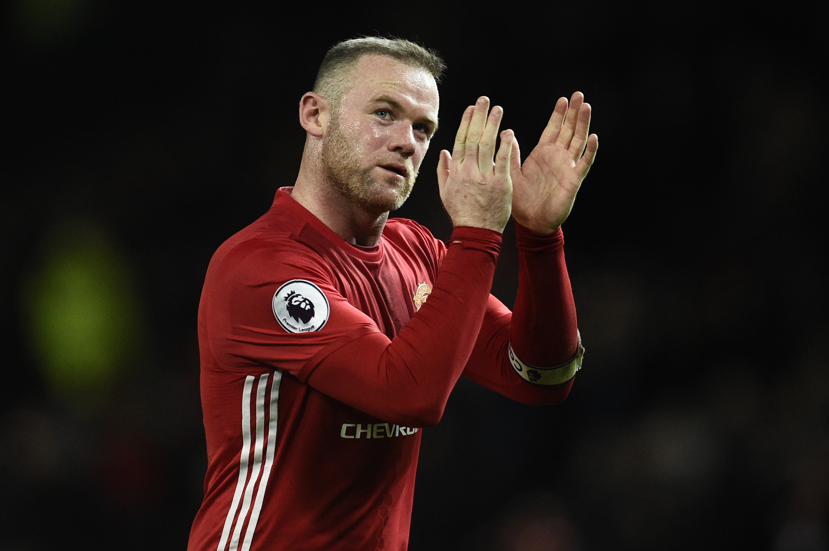 Manchester United's English striker Wayne Rooney applauds the fans following the English Premier League football match between Manchester United and Hull City at Old Trafford in Manchester, north west England, on February 1, 2017.
The match ended in a draw at 0-0. / AFP / Oli SCARFF / RESTRICTED TO EDITORIAL USE. No use with unauthorized audio, video, data, fixture lists, club/league logos or 'live' services. Online in-match use limited to 75 images, no video emulation. No use in betting, games or single club/league/player publications. / (Photo credit should read OLI SCARFF/AFP/Getty Images)