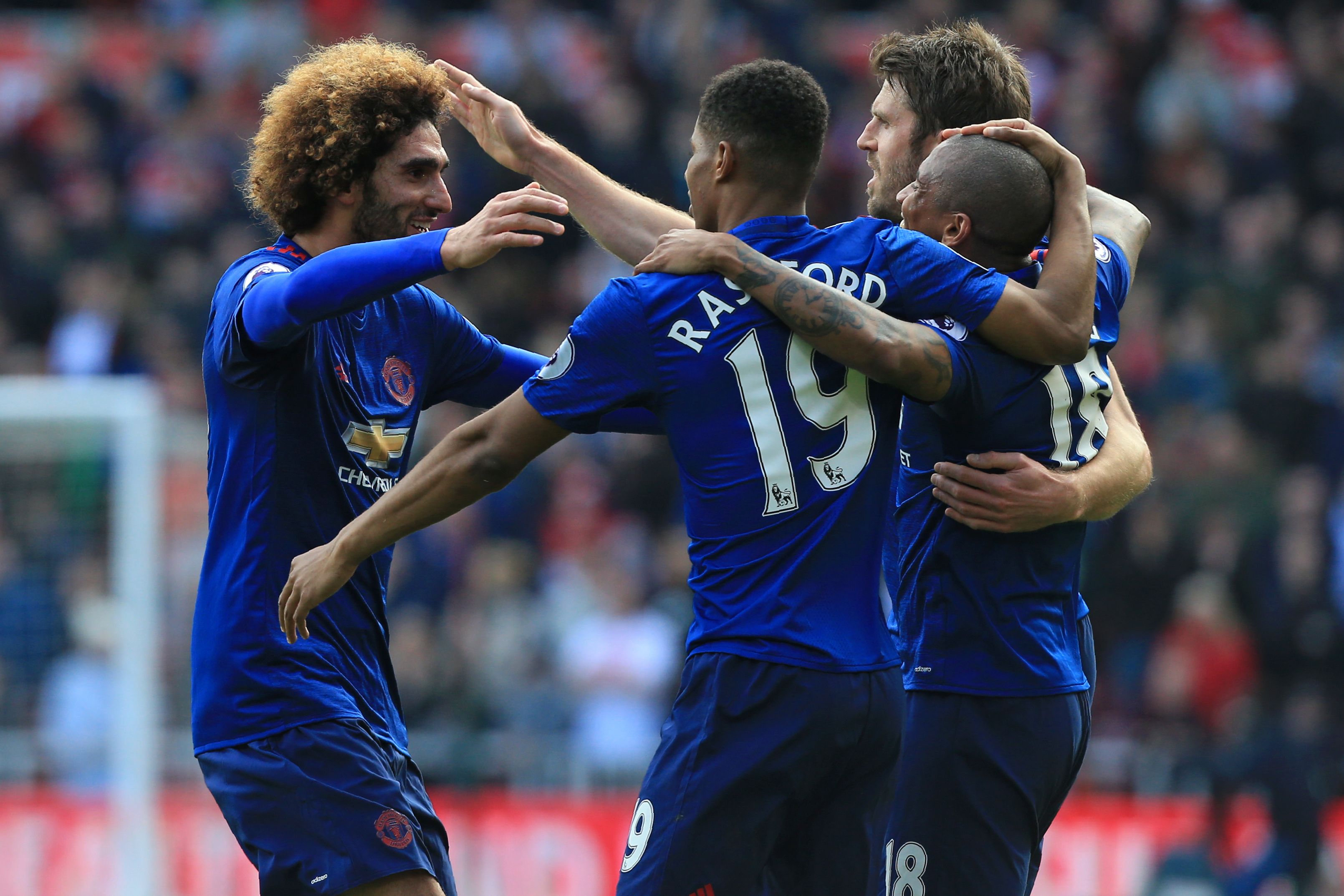 Manchester United's Belgian midfielder Marouane Fellaini (L) celebrates with teammates after scoring the opening goal of the English Premier League football match between Middlesbrough and Manchester United at Riverside Stadium in Middlesbrough, north east England on March 19, 2017. / AFP PHOTO / Lindsey PARNABY / RESTRICTED TO EDITORIAL USE. No use with unauthorized audio, video, data, fixture lists, club/league logos or 'live' services. Online in-match use limited to 75 images, no video emulation. No use in betting, games or single club/league/player publications.  /         (Photo credit should read LINDSEY PARNABY/AFP/Getty Images)