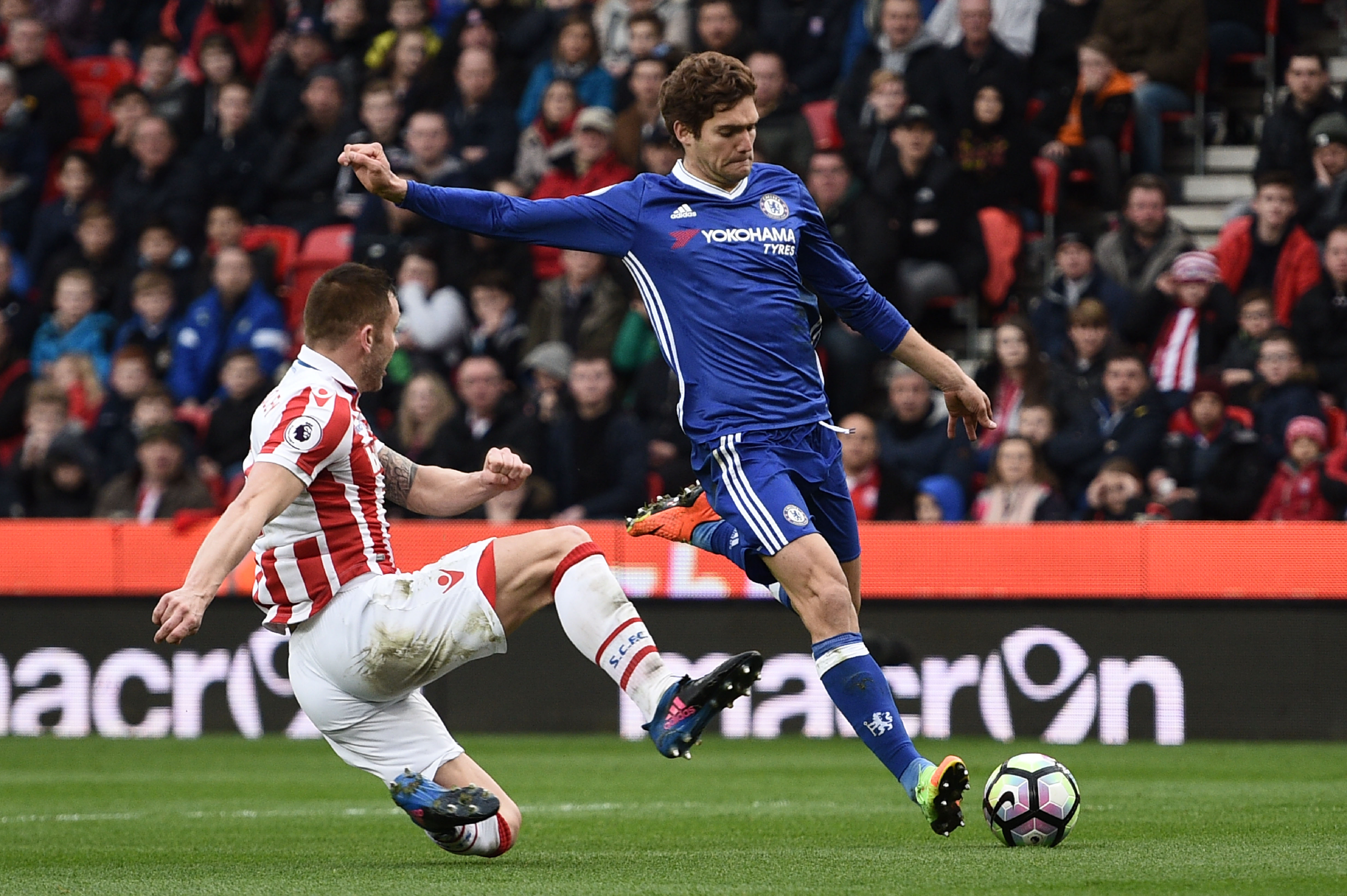 Stoke City's English-born Scottish defender Phil Bardsley (L) tries to block a shot by Chelsea's Spanish defender Marcos Alonso during the English Premier League football match between Stoke City and Chelsea at the Bet365 Stadium in Stoke-on-Trent, central England on March 18, 2017. / AFP PHOTO / Oli SCARFF / RESTRICTED TO EDITORIAL USE. No use with unauthorized audio, video, data, fixture lists, club/league logos or 'live' services. Online in-match use limited to 75 images, no video emulation. No use in betting, games or single club/league/player publications. / (Photo credit should read OLI SCARFF/AFP/Getty Images)