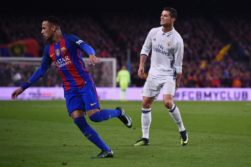 Real Madrid's Portuguese forward Cristiano Ronaldo (R) grimaces past Barcelona's Brazilian forward Neymar during the Spanish league football match FC Barcelona vs Real Madrid CF at the Camp Nou stadium in Barcelona on December 3, 2016. / AFP / JOSEP LAGO (Photo credit should read JOSEP LAGO/AFP/Getty Images)