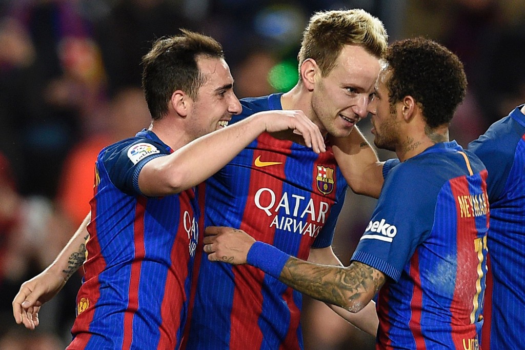 Barcelona's Croatian midfielder Ivan Rakitic (C) celebrates with Barcelona's Brazilian forward Neymar (R) and Barcelona's forward Paco Alcacer after scoring during the Spanish league football match FC Barcelona vs Real Sporting de Gijon at the Camp Nou stadium in Barcelona on March 1, 2017. / AFP PHOTO / LLUIS GENE (Photo credit should read LLUIS GENE/AFP/Getty Images)