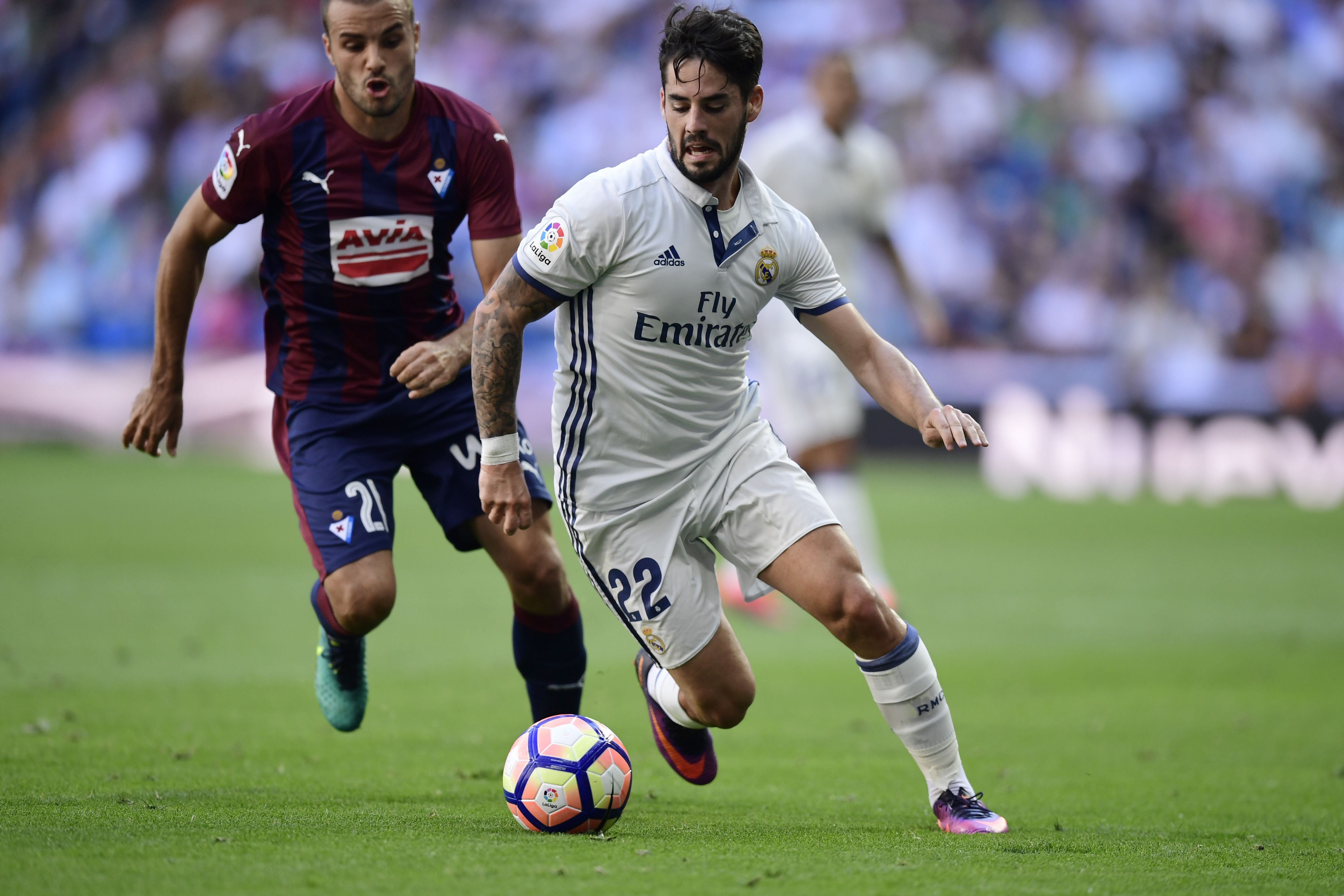 Real Madrid's midfielder Isco (R) vies with Eibar's midfielder Pedro Leon during the Spanish league football match Real Madrid CF vs SD Eibar at the Santiago Bernabeu stadium in Madrid on October 2, 2016. / AFP / JAVIER SORIANO        (Photo credit should read JAVIER SORIANO/AFP/Getty Images)