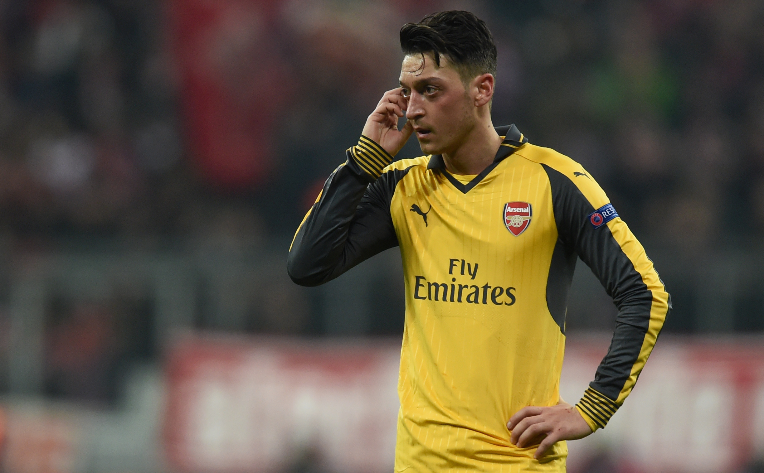 Arsenal's German midfielder Mesut Ozil reacts during the UEFA Champions League round of sixteen football match between FC Bayern Munich and Arsenal in Munich, southern Germany, on February 15, 2017. / AFP / Christof STACHE (Photo credit should read CHRISTOF STACHE/AFP/Getty Images)