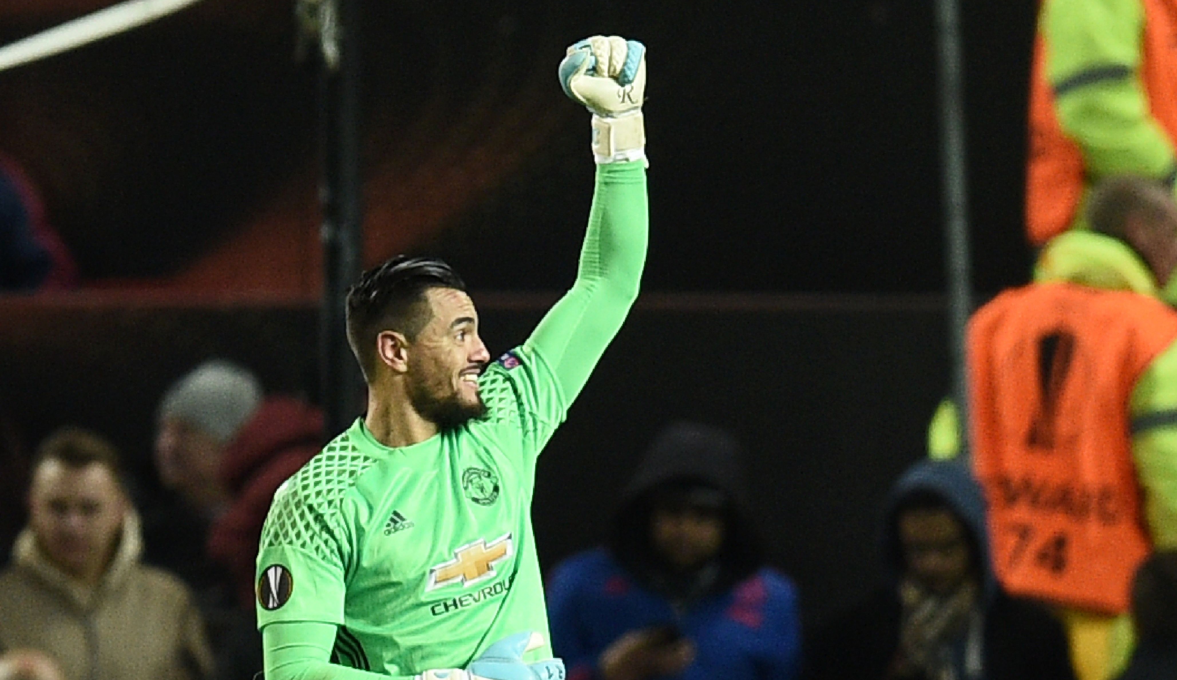 Manchester United's Argentinian goalkeeper Sergio Romero celebrates at the final whistle during the UEFA Europa League round of 16 second-leg football match between Manchester United and FC Rostov at Old Trafford stadium in Manchester, north-west England, on March 16, 2017. / AFP PHOTO / Oli SCARFF (Photo credit should read OLI SCARFF/AFP/Getty Images)