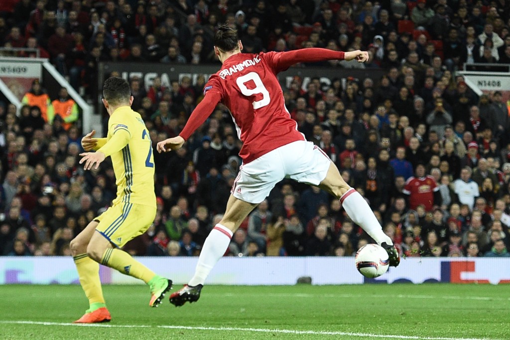 Manchester United's Swedish striker Zlatan Ibrahimovic (R) does a backward flick to lay the ball off for Manchester United's Spanish midfielder Juan Mata (unseen) to score the opening goal during the UEFA Europa League round of 16 second-leg football match between Manchester United and FC Rostov at Old Trafford stadium in Manchester, north-west England, on March 16, 2017. / AFP PHOTO / Oli SCARFF (Photo credit should read OLI SCARFF/AFP/Getty Images)