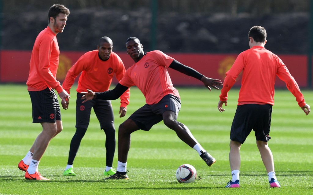 Manchester United's English midfielder Michael Carrick (L) and Manchester United's French midfielder Paul Pogba (C) take part in a training session at their Carrington base in Manchester, north west England, on March 15, 2017, on the eve of their UEFA Europa League Round of 16 second-leg football match against Rostov. / AFP PHOTO / Paul ELLIS (Photo credit should read PAUL ELLIS/AFP/Getty Images)