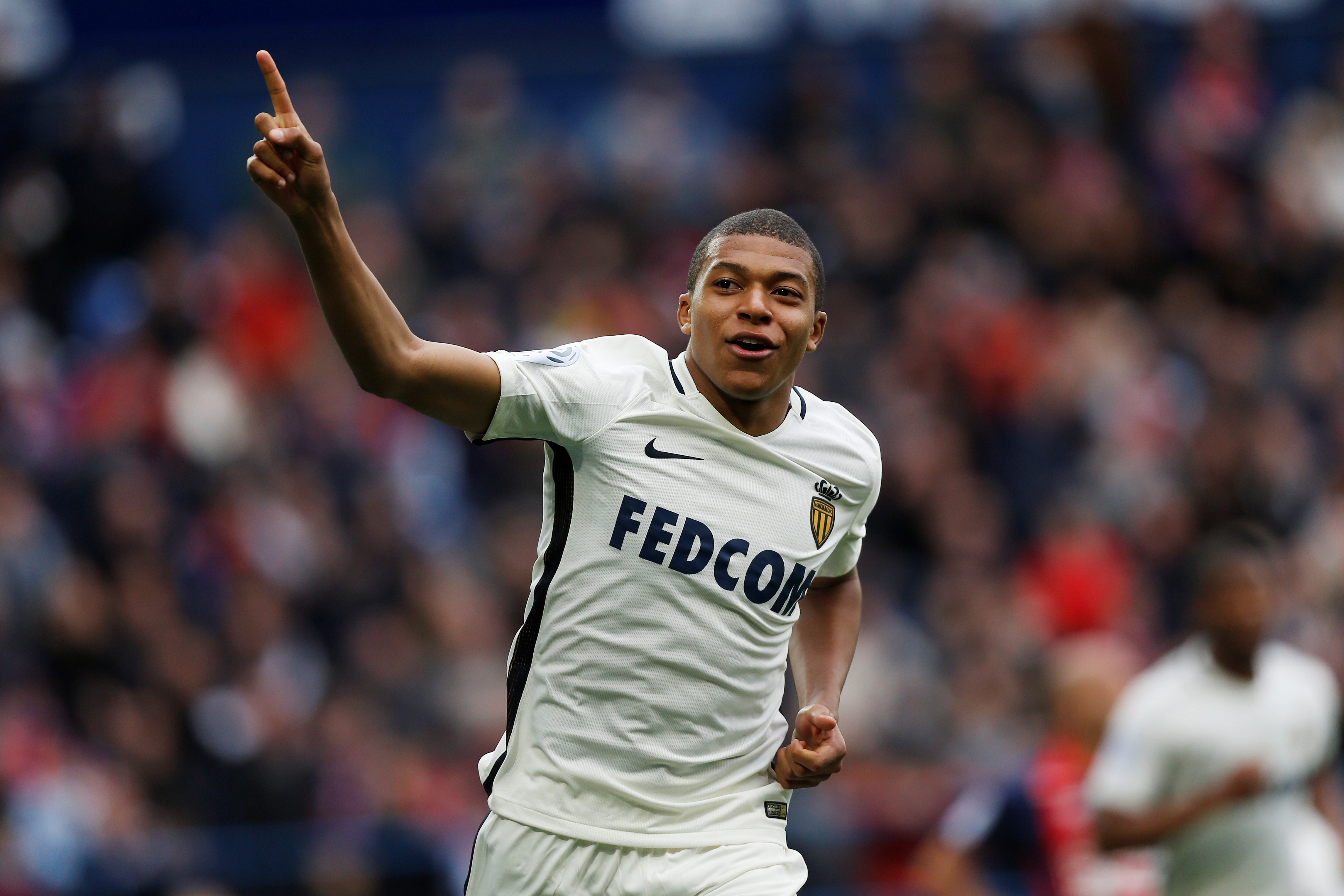 Monaco's French forward Kylian Mbappe Lottin celebrates after scoring a goal during the French L1 football match between Caen (SMC) and Monaco (AS), on March 19, 2017 at the Michel d'Ornano stadium, in Caen, northwestern France. / AFP PHOTO / CHARLY TRIBALLEAU (Photo credit should read CHARLY TRIBALLEAU/AFP/Getty Images)