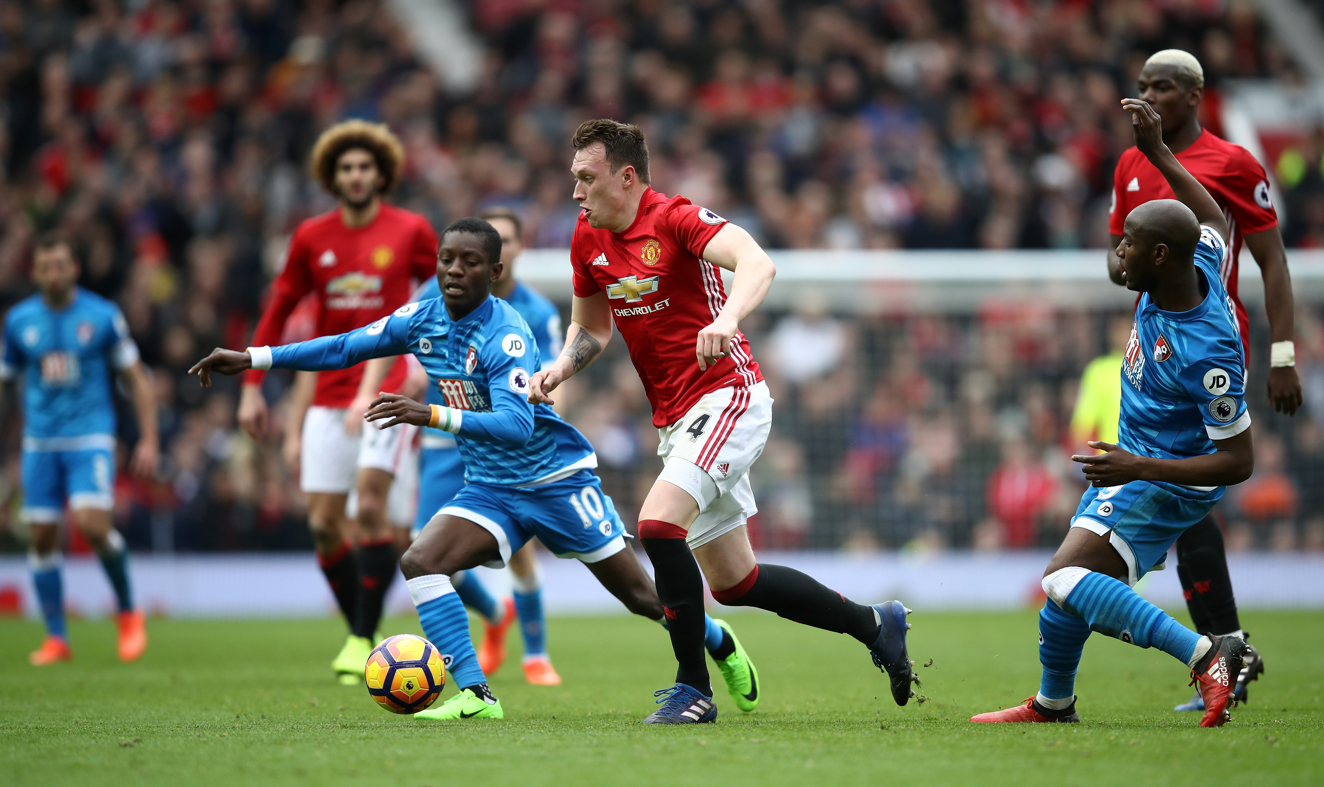MANCHESTER, ENGLAND - MARCH 04: Max Gradel of AFC Bournemouth (L) attempts to take the ball the past Phil Jones of Manchester United (C) during the Premier League match between Manchester United and AFC Bournemouth at Old Trafford on March 4, 2017 in Manchester, England. (Photo by Julian Finney/Getty Images)