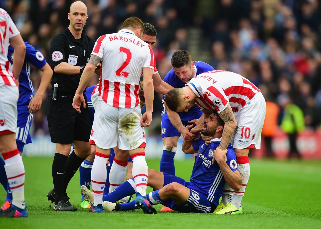 STOKE ON TRENT, ENGLAND - MARCH 18: Marko Arnautovic of Stoke City helps Diego Costa of Chelsea off the ground during the Premier League match between Stoke City and Chelsea at Bet365 Stadium on March 18, 2017 in Stoke on Trent, England. (Photo by Tony Marshall/Getty Images)