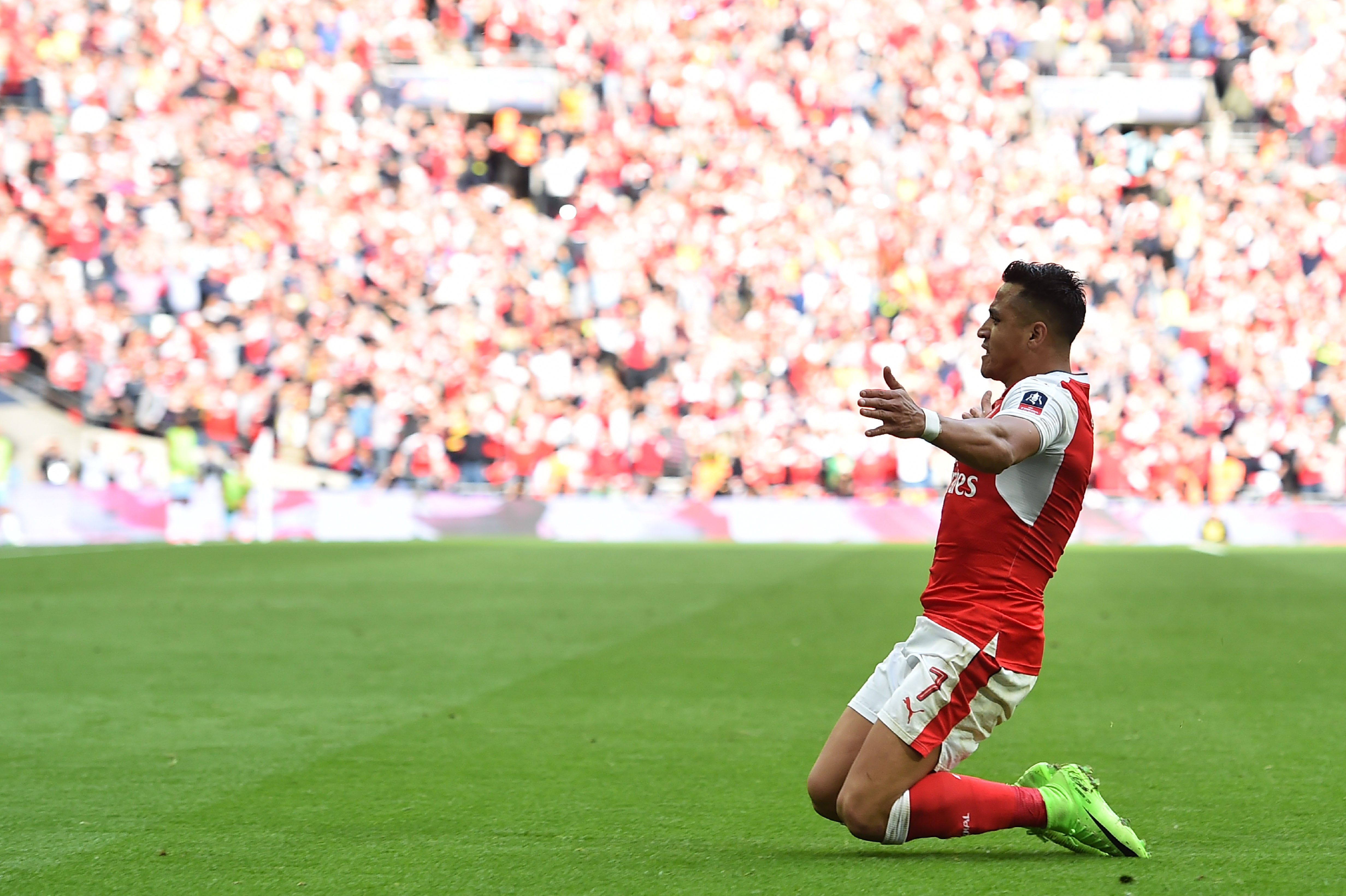 Arsenal's Chilean striker Alexis Sanchez celebrates scoring their second goal during the FA Cup semi-final football match between Arsenal and Manchester City at Wembley stadium in London on April 23, 2017. / AFP PHOTO / Glyn KIRK / NOT FOR MARKETING OR ADVERTISING USE / RESTRICTED TO EDITORIAL USE
(Photo credit should read GLYN KIRK/AFP/Getty Images)