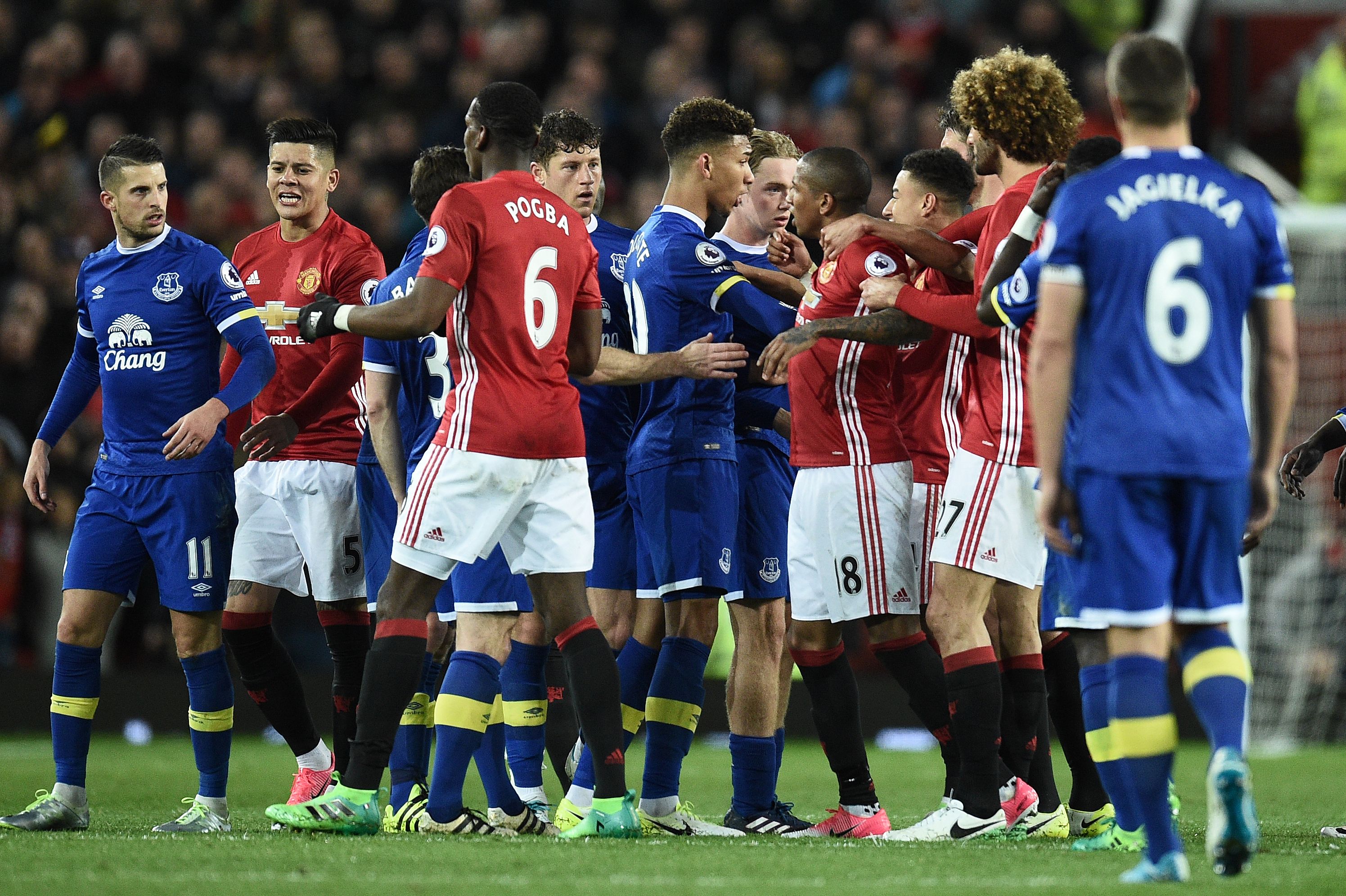 Everton's Belgian striker Kevin Mirallas (L) remonstrates with Manchester United's French midfielder Paul Pogba (3L) as Everton's English defender Mason Holgate (C) remonstrates with Manchester United's English midfielder Ashley Young (4R) during the English Premier League football match between Manchester United and Everton at Old Trafford in Manchester, north west England, on April 4, 2017. / AFP PHOTO / Oli SCARFF / RESTRICTED TO EDITORIAL USE. No use with unauthorized audio, video, data, fixture lists, club/league logos or 'live' services. Online in-match use limited to 75 images, no video emulation. No use in betting, games or single club/league/player publications. / (Photo credit should read OLI SCARFF/AFP/Getty Images)