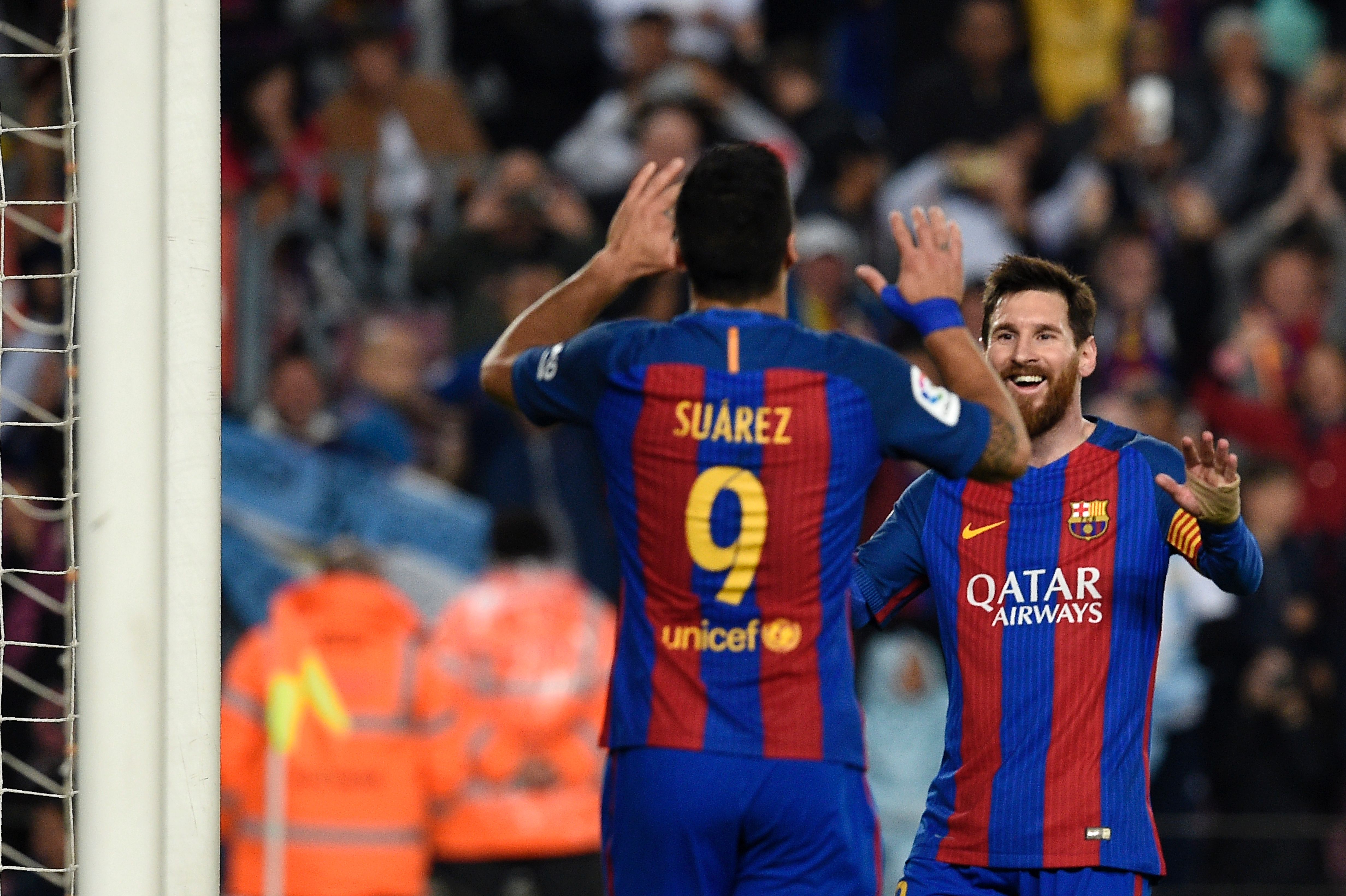Barcelona's Argentinian forward Lionel Messi (R) celebrates with Barcelona's Uruguayan forward Luis Suarez after scoring a goal during the Spanish league football match FC Barcelona vs Real Sociedad at the Camp Nou stadium in Barcelona on April 15, 2017. / AFP PHOTO / LLUIS GENE (Photo credit should read LLUIS GENE/AFP/Getty Images)