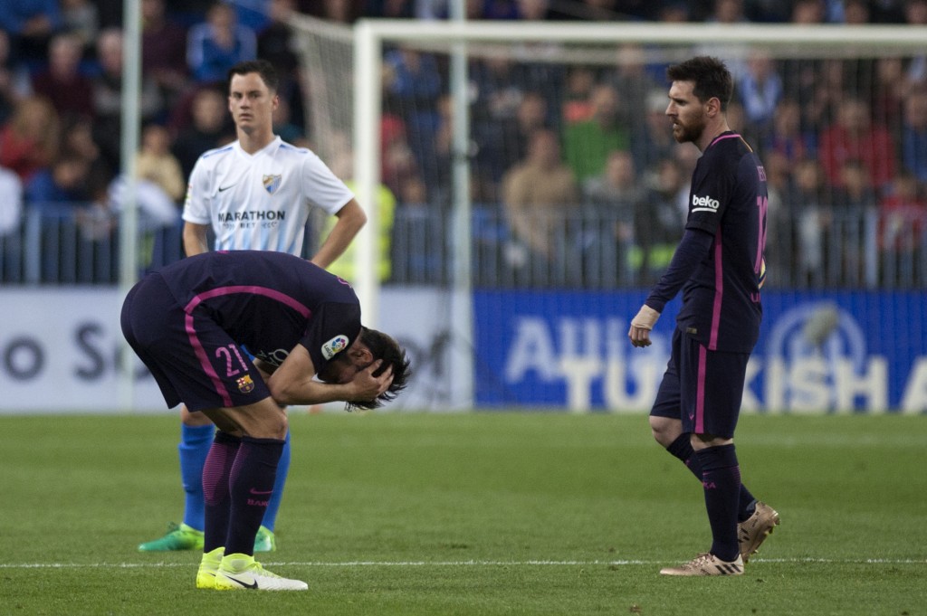 Barcelona's Portuguese midfielder Andre Gomes (L) and Barcelona's Argentinian forward Lionel Messi stand on the field during the Spanish league football match Malaga CF vs FC Barcelona at La Rosaleda stadium in Malaga on April 8, 2017. / AFP PHOTO / JORGE GUERRERO (Photo credit should read JORGE GUERRERO/AFP/Getty Images)