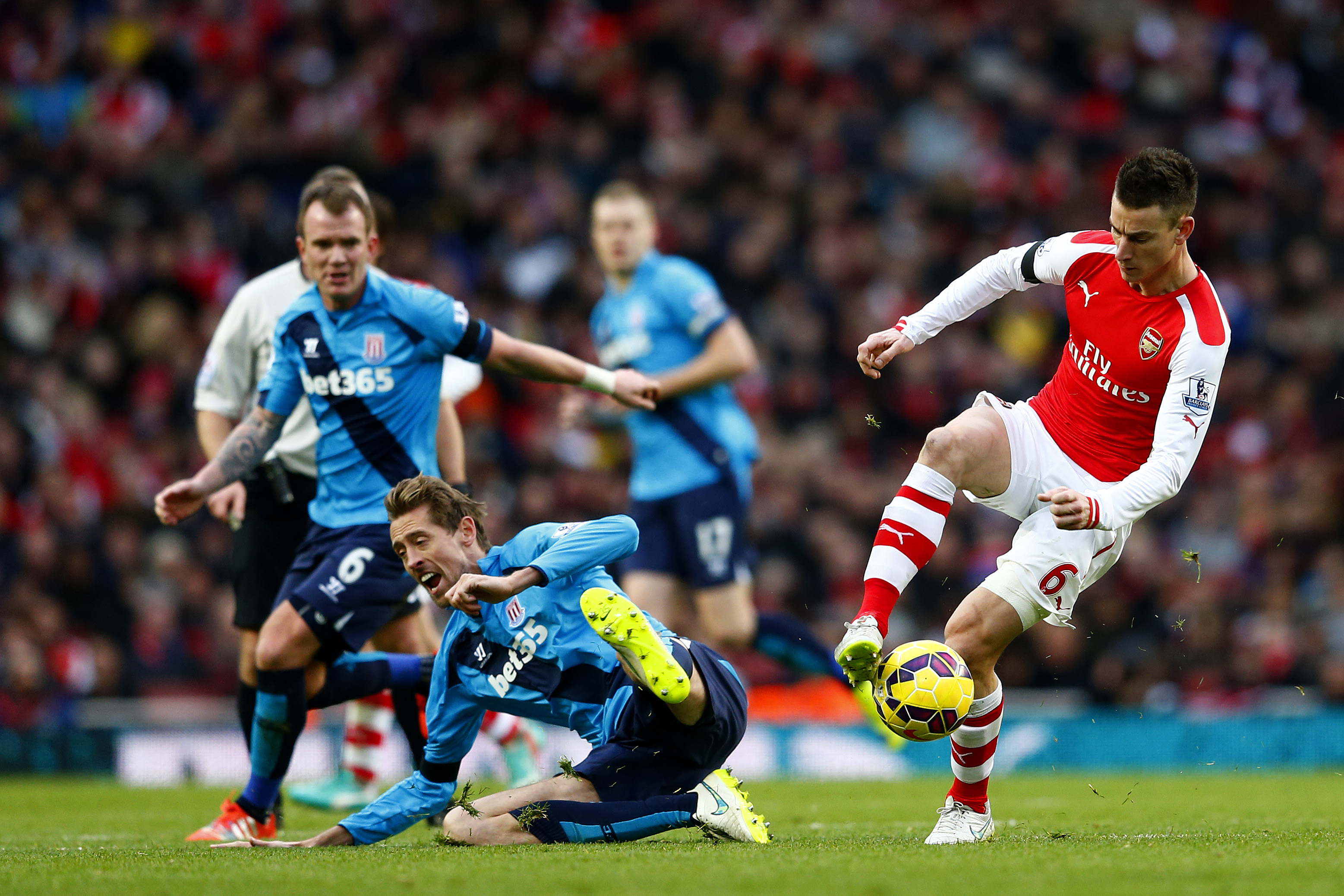 LONDON, ENGLAND - JANUARY 11: Laurent Koscielny of Arsenal battles for the ball with Peter Crouch of Stoke City during the Barclays Premier League match between Arsenal and Stoke City at Emirates Stadium on January 11, 2015 in London, England. (Photo by Julian Finney/Getty Images)