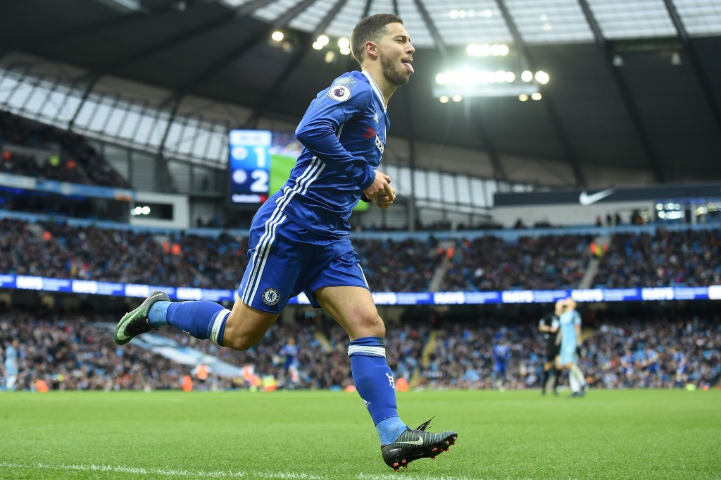 Chelsea's Belgian midfielder Eden Hazard celebrates scoring his team's third goal during the English Premier League football match between Manchester City and Chelsea at the Etihad Stadium in Manchester, north west England, on December 3, 2016. / AFP / Paul ELLIS / RESTRICTED TO EDITORIAL USE. No use with unauthorized audio, video, data, fixture lists, club/league logos or 'live' services. Online in-match use limited to 75 images, no video emulation. No use in betting, games or single club/league/player publications. / (Photo credit should read PAUL ELLIS/AFP/Getty Images)