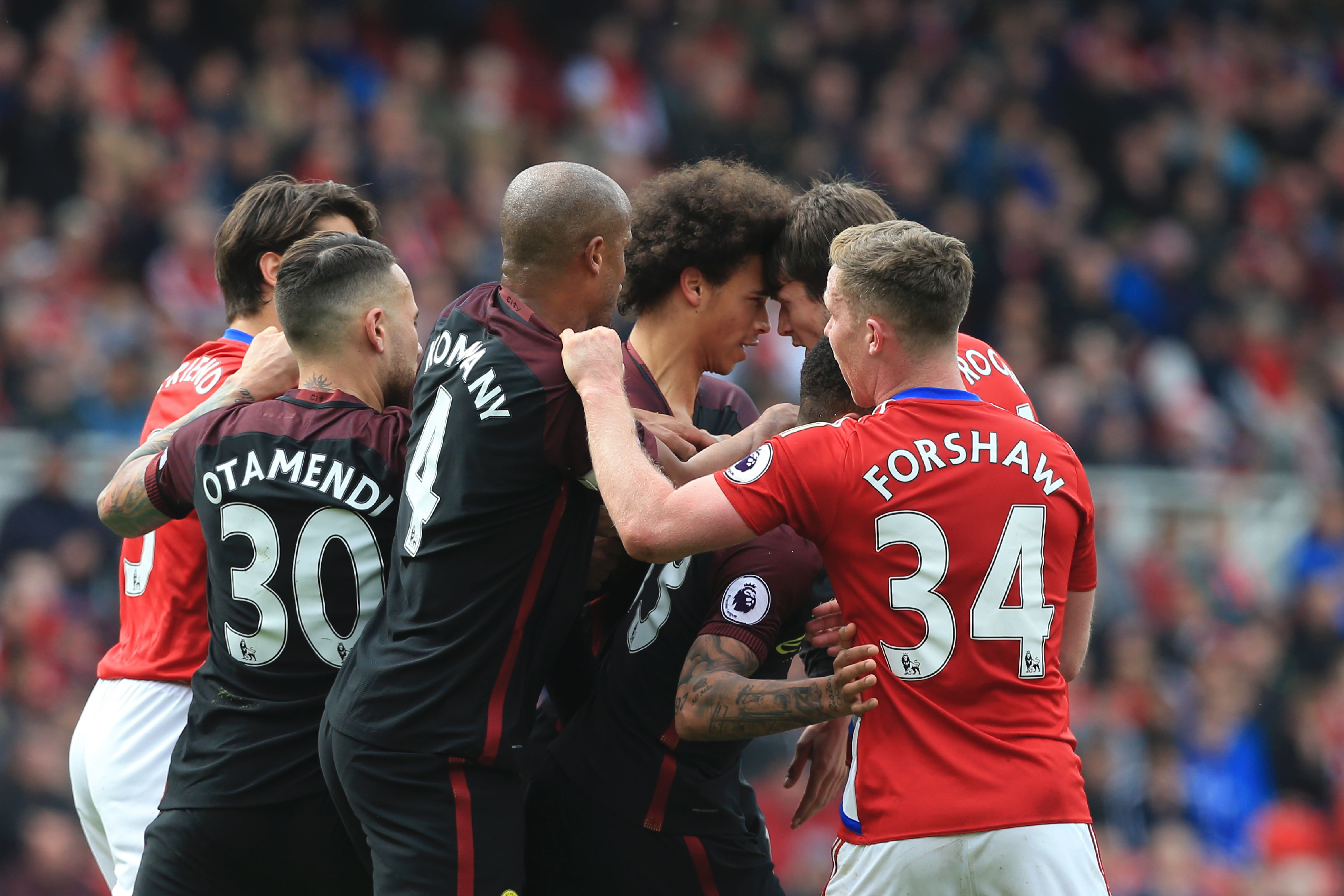 Manchester City's German midfielder Leroy Sane (3R) and Middlesbrough's Dutch midfielder Marten de Roon (2R) confront each other during the English Premier League football match between Middlesbrough and Manchester City at Riverside Stadium in Middlesbrough, northeast England on April 30, 2017. / AFP PHOTO / Lindsey PARNABY / RESTRICTED TO EDITORIAL USE. No use with unauthorized audio, video, data, fixture lists, club/league logos or 'live' services. Online in-match use limited to 75 images, no video emulation. No use in betting, games or single club/league/player publications. / (Photo credit should read LINDSEY PARNABY/AFP/Getty Images)