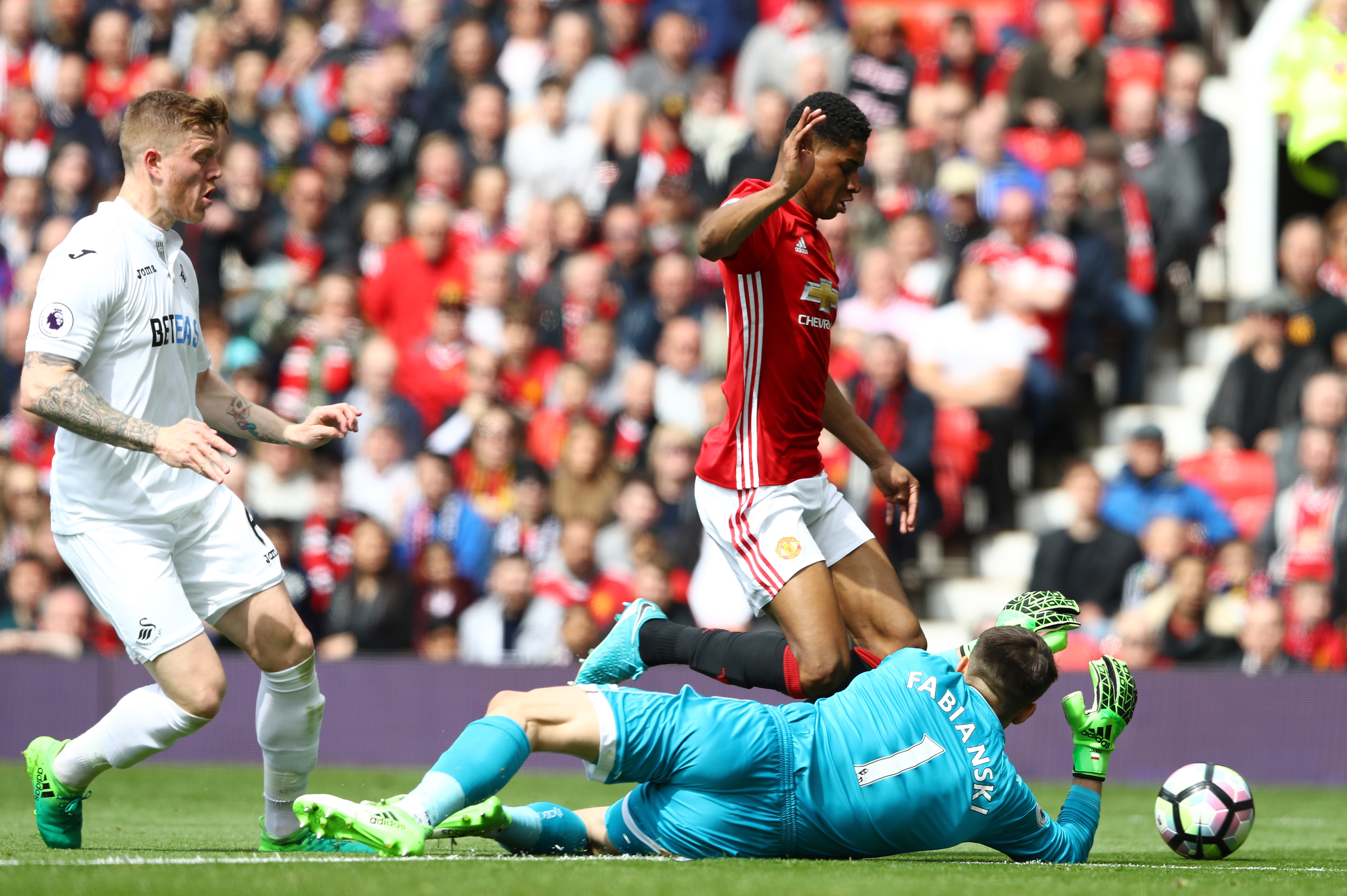MANCHESTER, ENGLAND - APRIL 30: Marcus Rashford of Manchester United is fouled by Lukasz Fabianski of Swansea City and a penalty is awarded to Manchester United during the Premier League match between Manchester United and Swansea City at Old Trafford on April 30, 2017 in Manchester, England. (Photo by Michael Steele/Getty Images)
