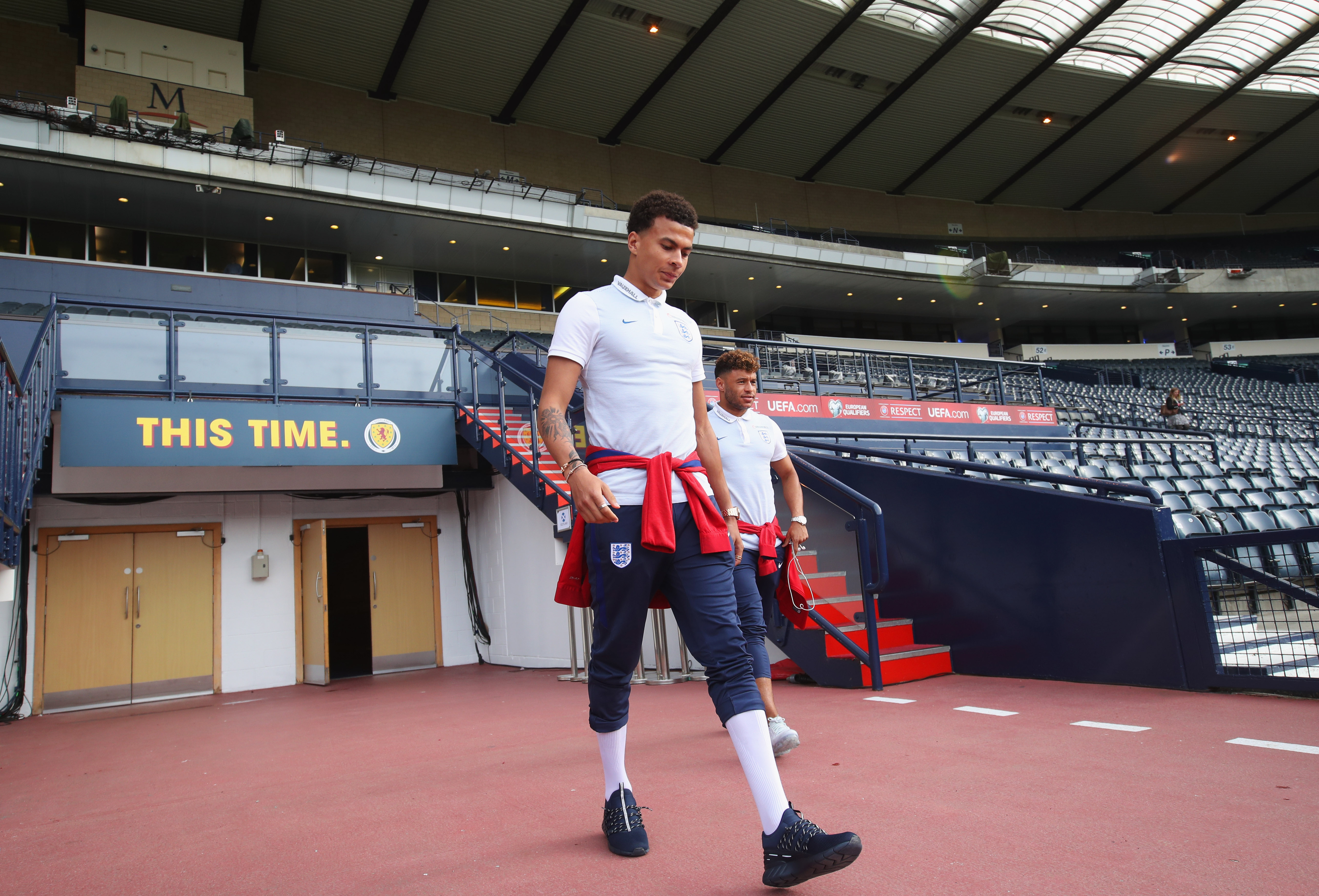 GLASGOW, SCOTLAND - JUNE 09: Dele Alli of England (front) walks on the pitch with team mate Alex Oxlade-Chamberlain on the eve of their FIFA World Cup qualifier against Scotland at Hampden Park on June 9, 2017 in Glasgow, Scotland. (Photo by Steve Welsh/Getty Images)
