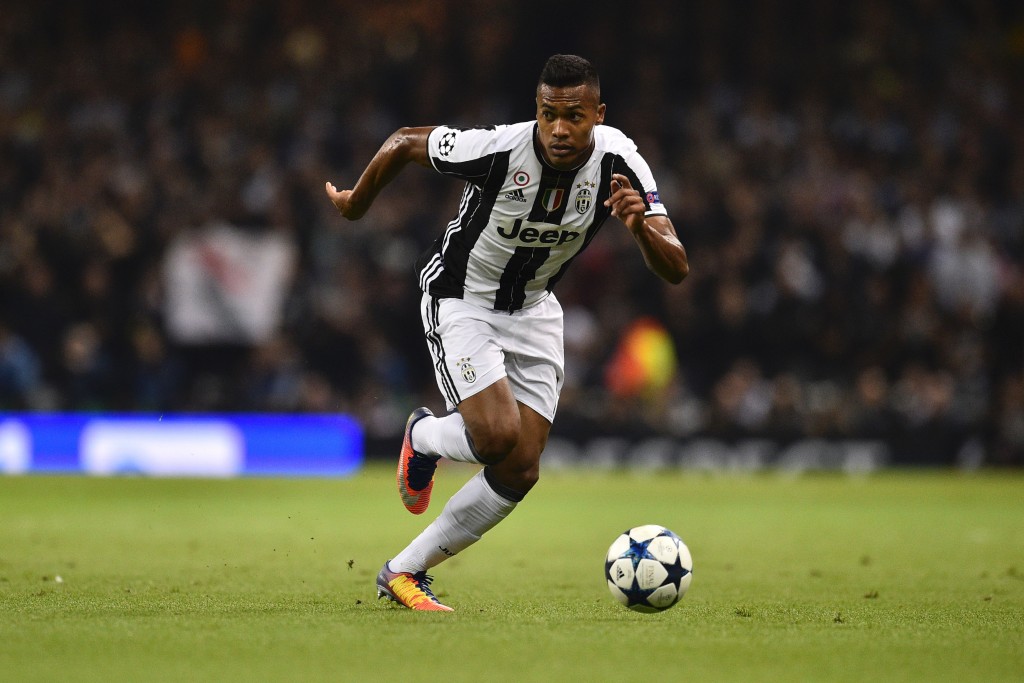 Juventus' Brazilian defender Alex Sandro runs with the ball during the UEFA Champions League final football match between Juventus and Real Madrid at The Principality Stadium in Cardiff, south Wales, on June 3, 2017. / AFP PHOTO / Glyn KIRK (Photo credit should read GLYN KIRK/AFP/Getty Images)